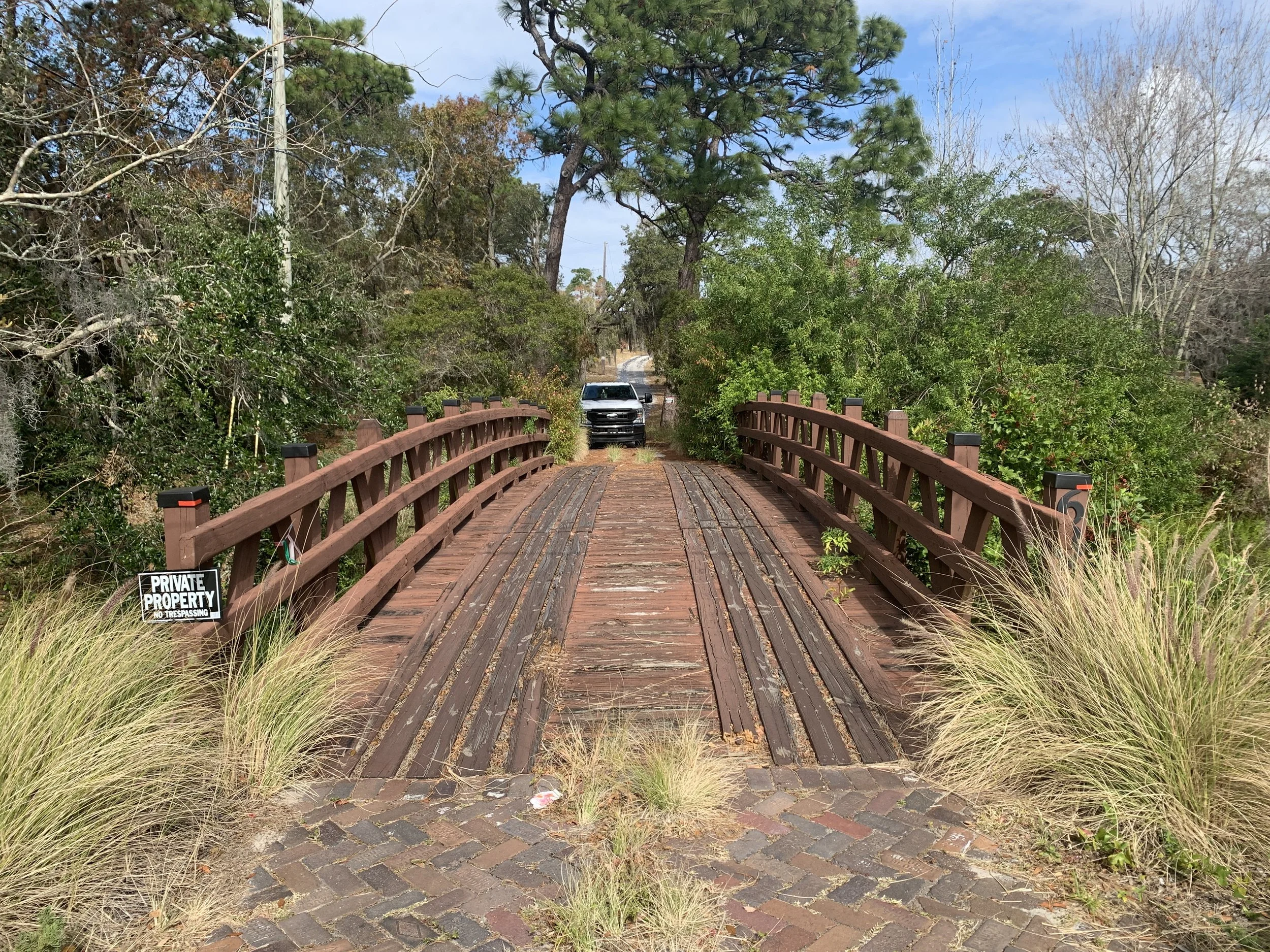 truck driving over vehicular timber bridge
