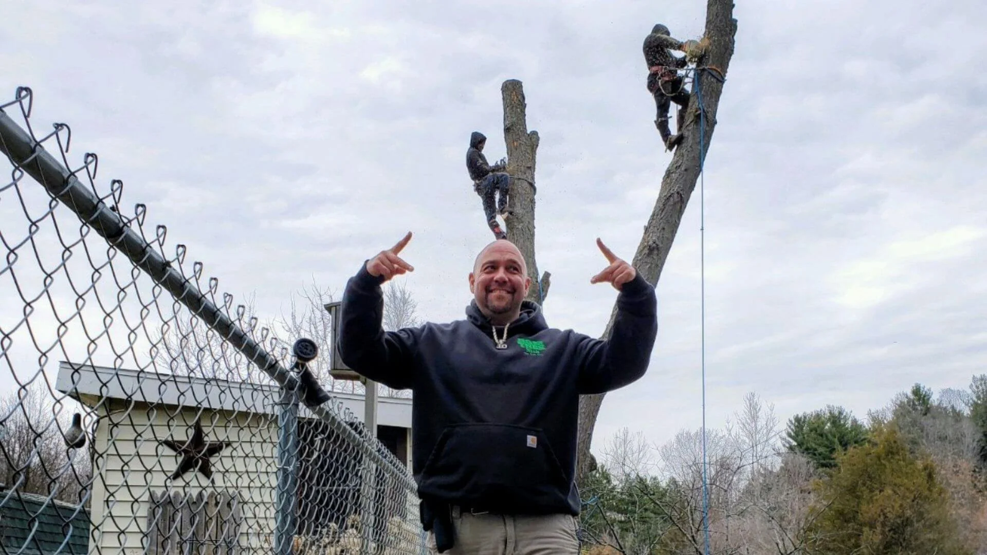 nick the tree guy standing in front of workers removing a tree
