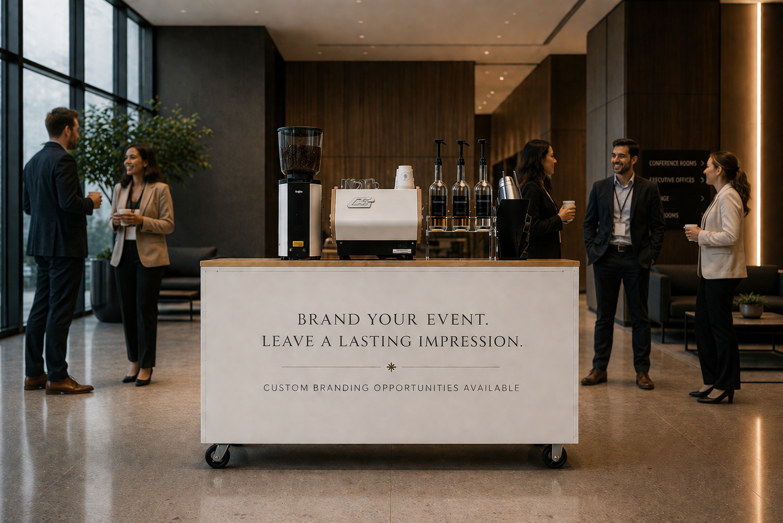 People in business attire standing and talking near a coffee station in a modern conference lobby.