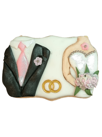 Decorative cake featuring a black tuxedo with pink tie, wedding dress with pearl necklace and pink flowers, and intertwined gold rings.