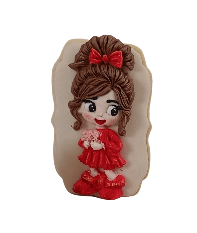 Decorated cookie featuring a cartoon girl with brown hair styled in a bun with a red bow, wearing a red dress and holding pink flowers, against a black background.