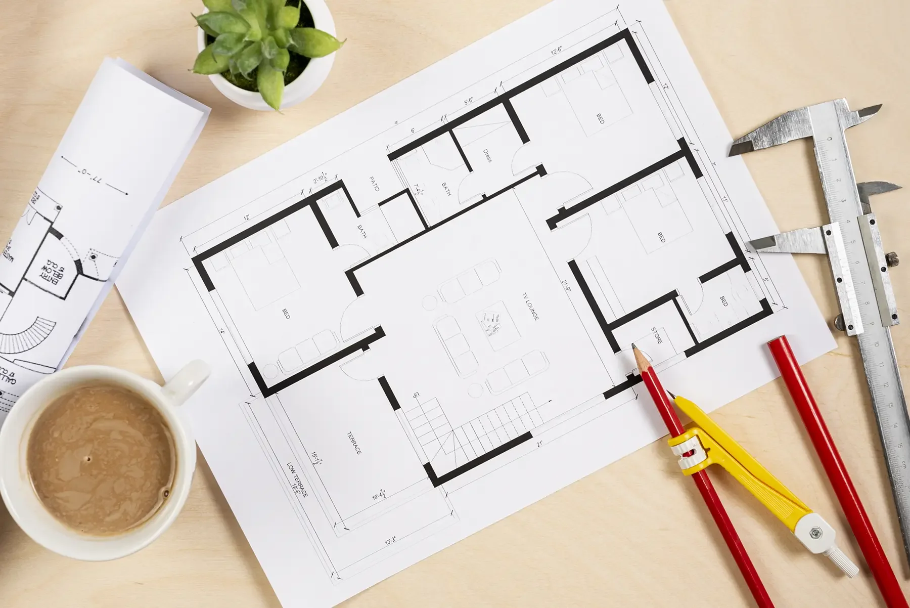 building regulations plans next to pencils on table