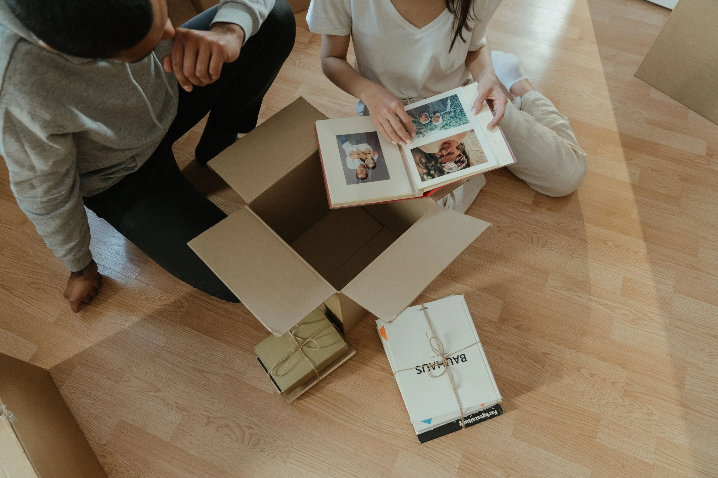 Family photo album resting on a box in a newly unpacked home