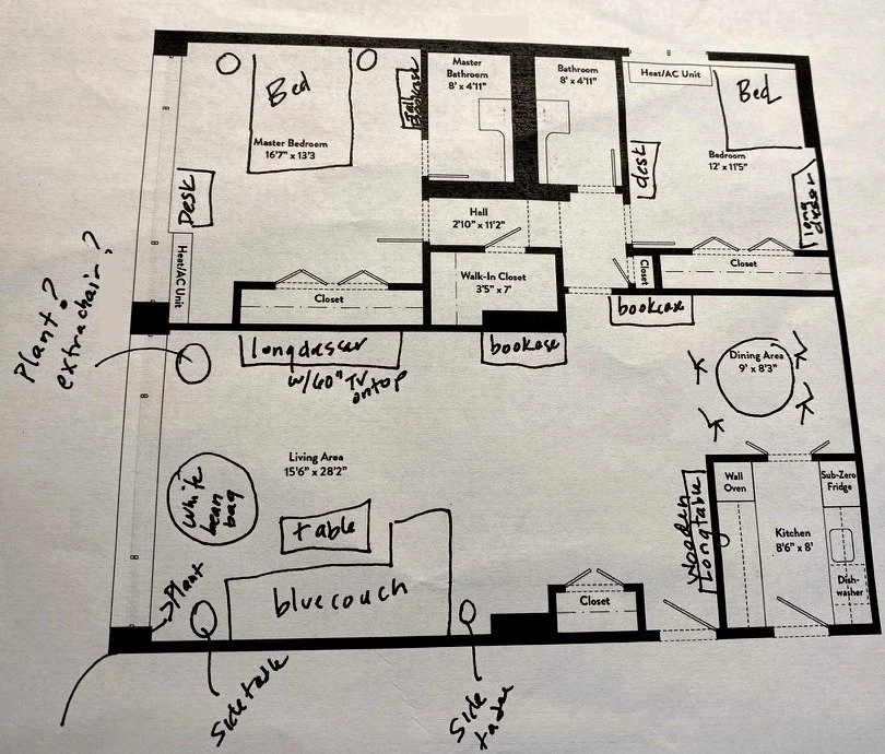 A printed apartment floor plan with furniture placement sketched in by hand, including a couch, beds, dressers, and bookcases, with handwritten notes and question marks in the margins