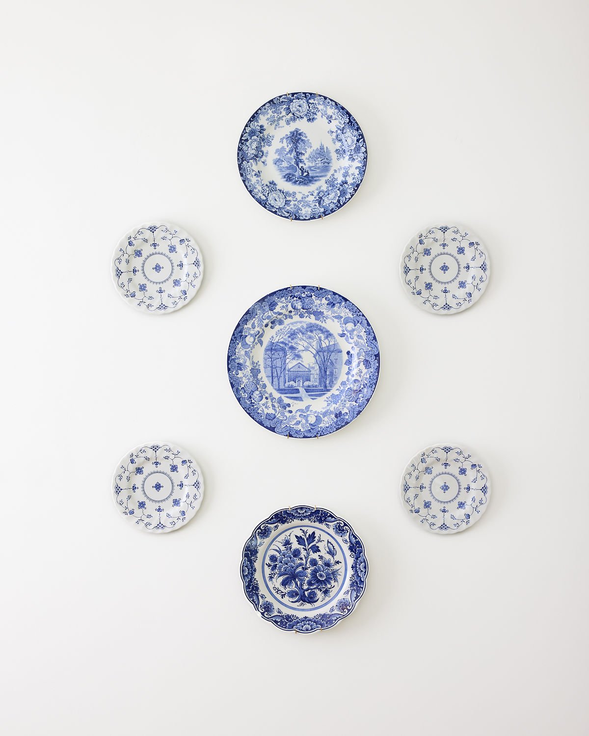 Curated blue and white plate gallery wall by The Tidy Girl, home organizer in Greater Boston