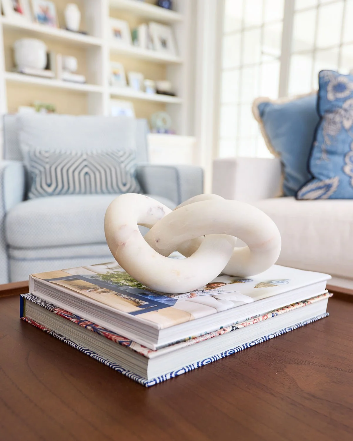 Styled, organized living room in soft blues by The Tidy Girl, professional home organizer.