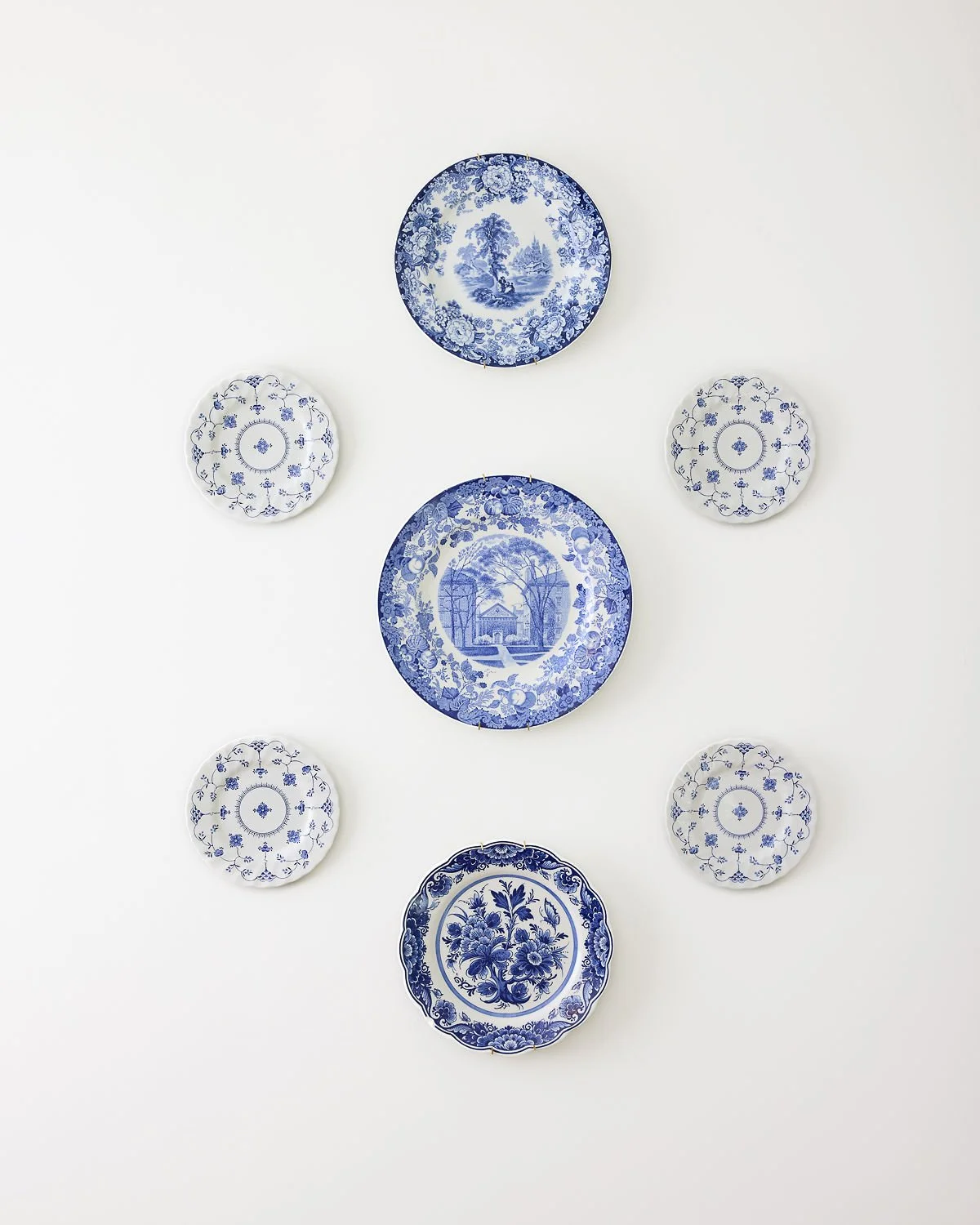 Curated blue and white plate gallery wall by The Tidy Girl, home organizer in Greater Boston