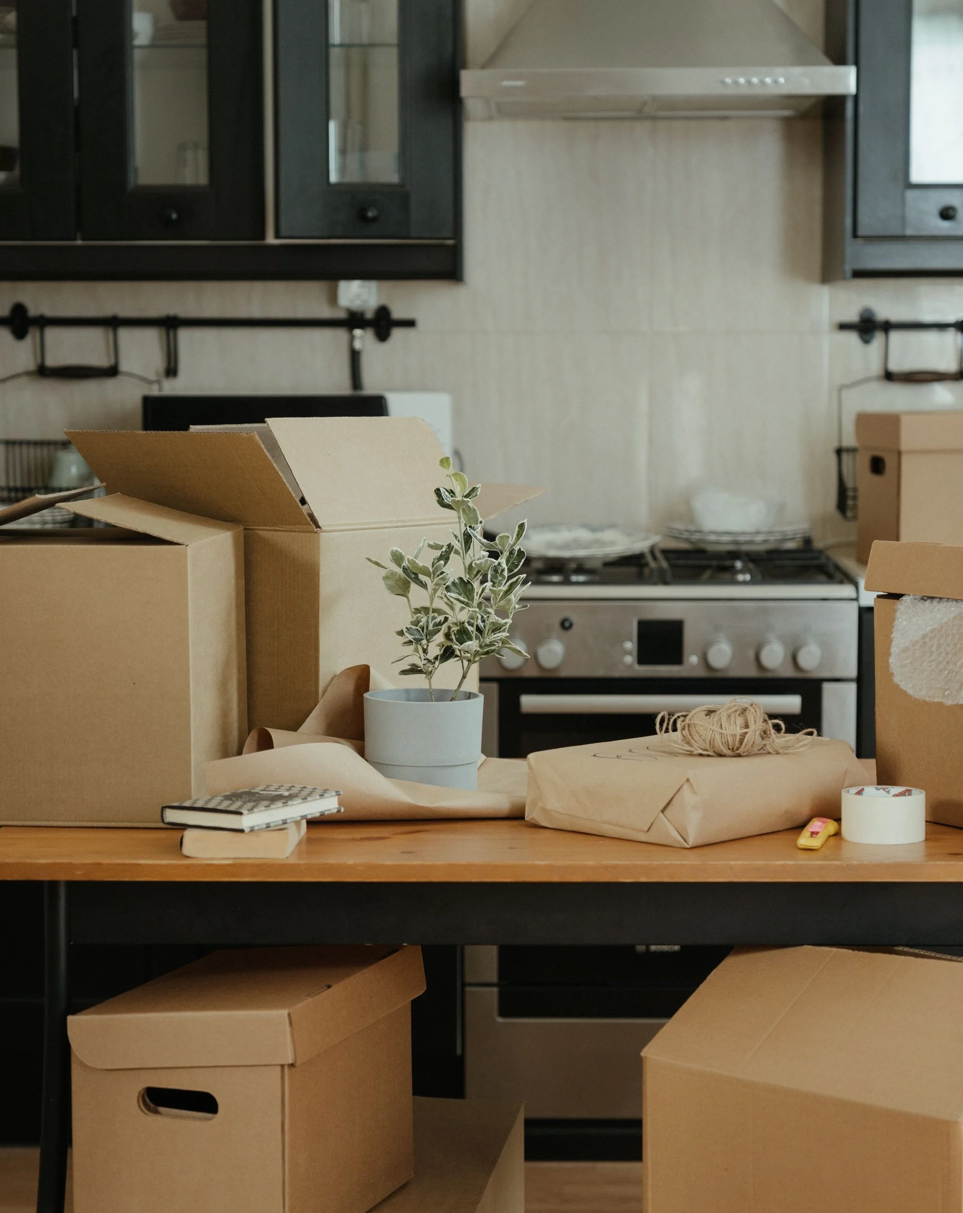 Kitchen with moving boxes being unpacked in a new home.
