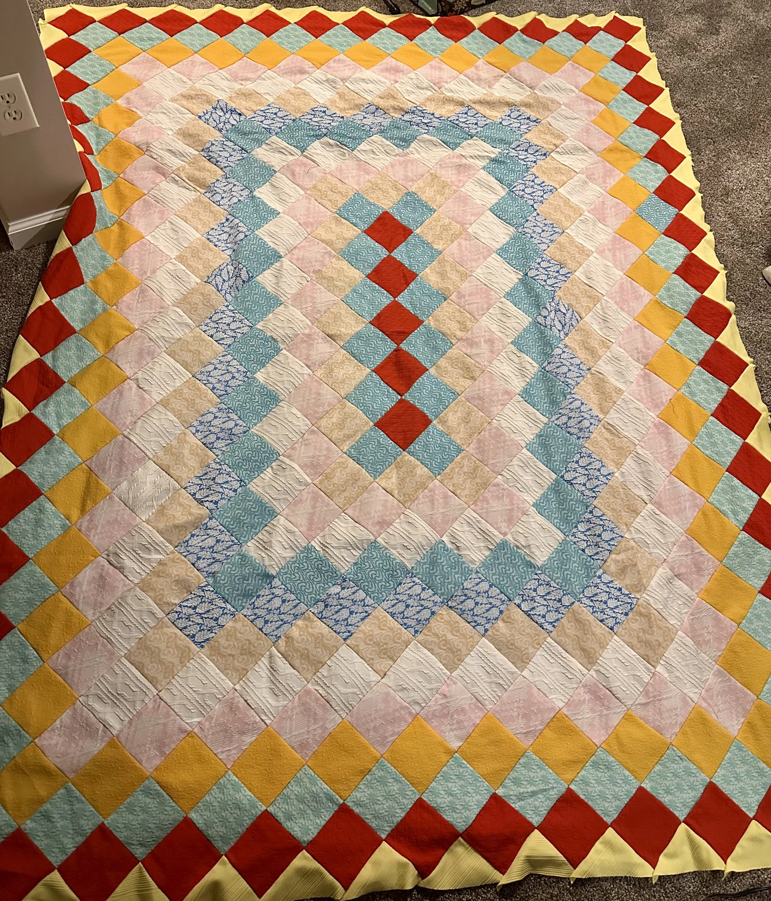 This quilt, once paused mid-stitch by loving hands long passed, found completion through restoration. This treasure began as an unfinished quilt top - stitched by loving hands now gone. Through care and attention, the puckers were eased and the seams