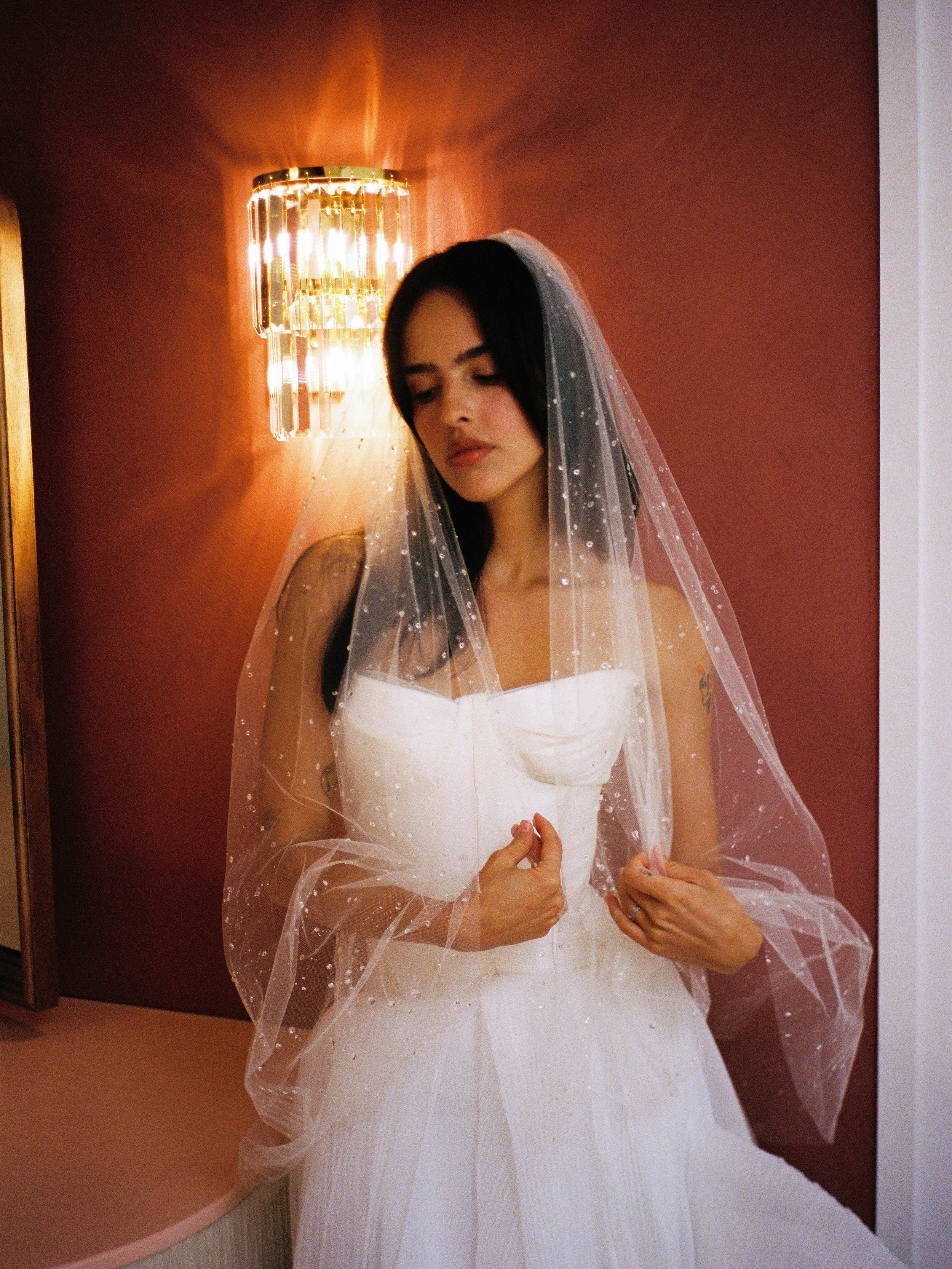 Tender moments captured in the Sweethearts Suite 🏹 

Shot on film by @emmadelreyphoto 
Dress/Veil @lovelybridemiami 
Florals @taguara.studio 
Bride @gabylaverde 
Inside @littlerosechapel 

-
#bridalportrait #filmphotography #bridalstyle #miamifilmph