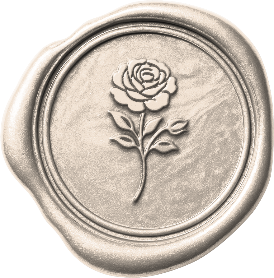 Close-up of a silver wax seal with a rose design embossed in the center.