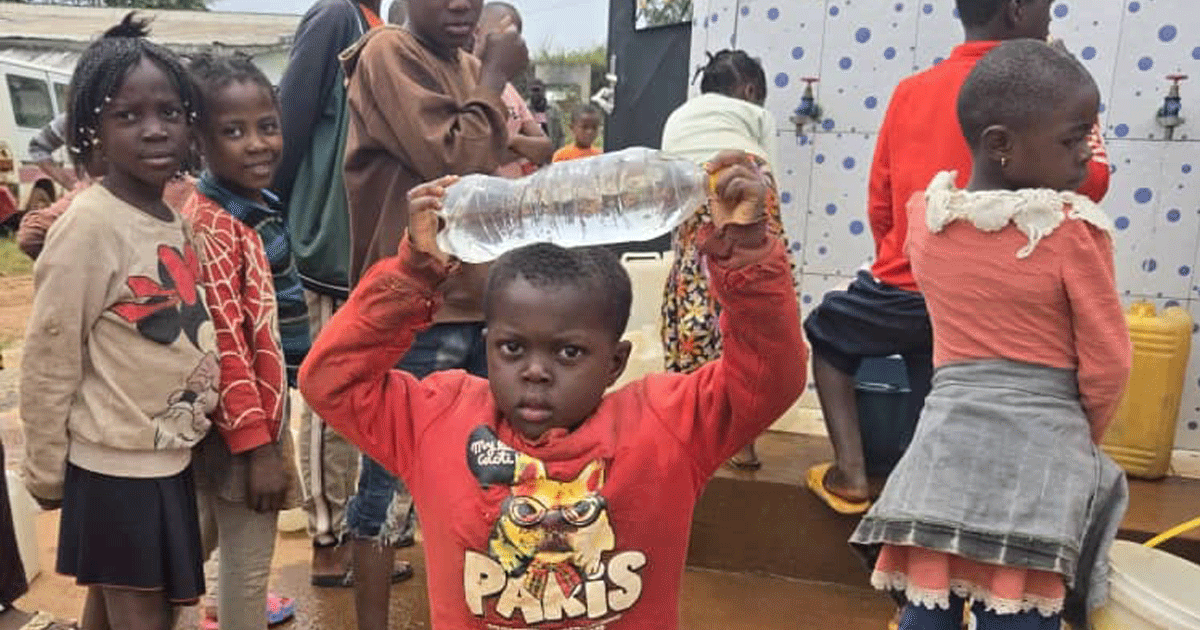 Nsoh Village children in Cameroon bring clean water home from the new water tank.