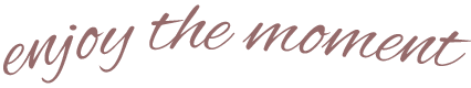 Text that says 'enjoy the moment' in cursive font