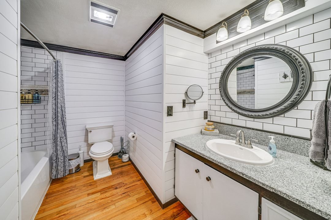 Large bathroom features tub and shower with plenty of space