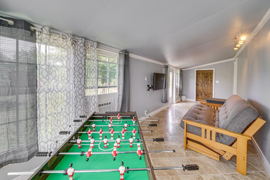 Back sunroom features fold out bed, laundry room, TV and foosball table