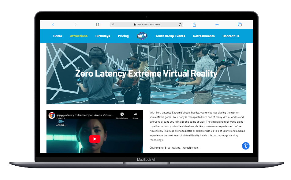 Laptop screen displaying a website for Zero Latency Extreme Virtual Reality, showing people using VR headsets and controllers in a virtual arena with a blue header menu and a video thumbnail.