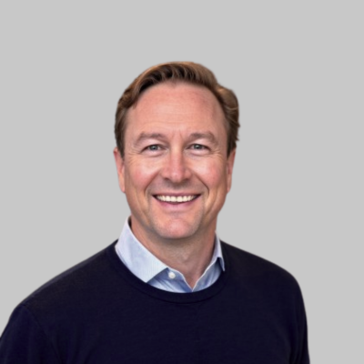 Man smiling with a grey background