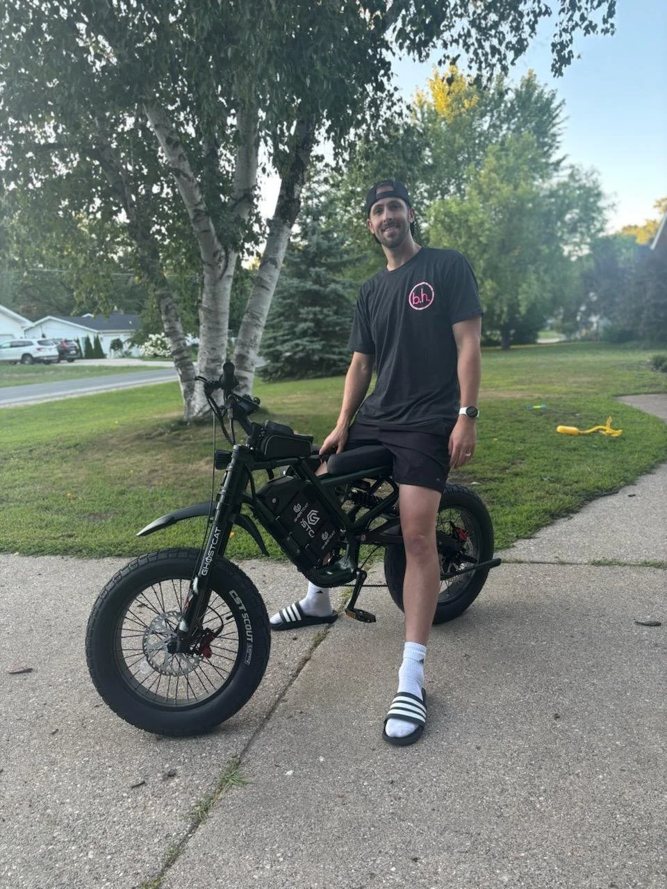 A financial advisor enjoying an electric bike ride through a local Michigan beach town, balancing hard work with active community living.