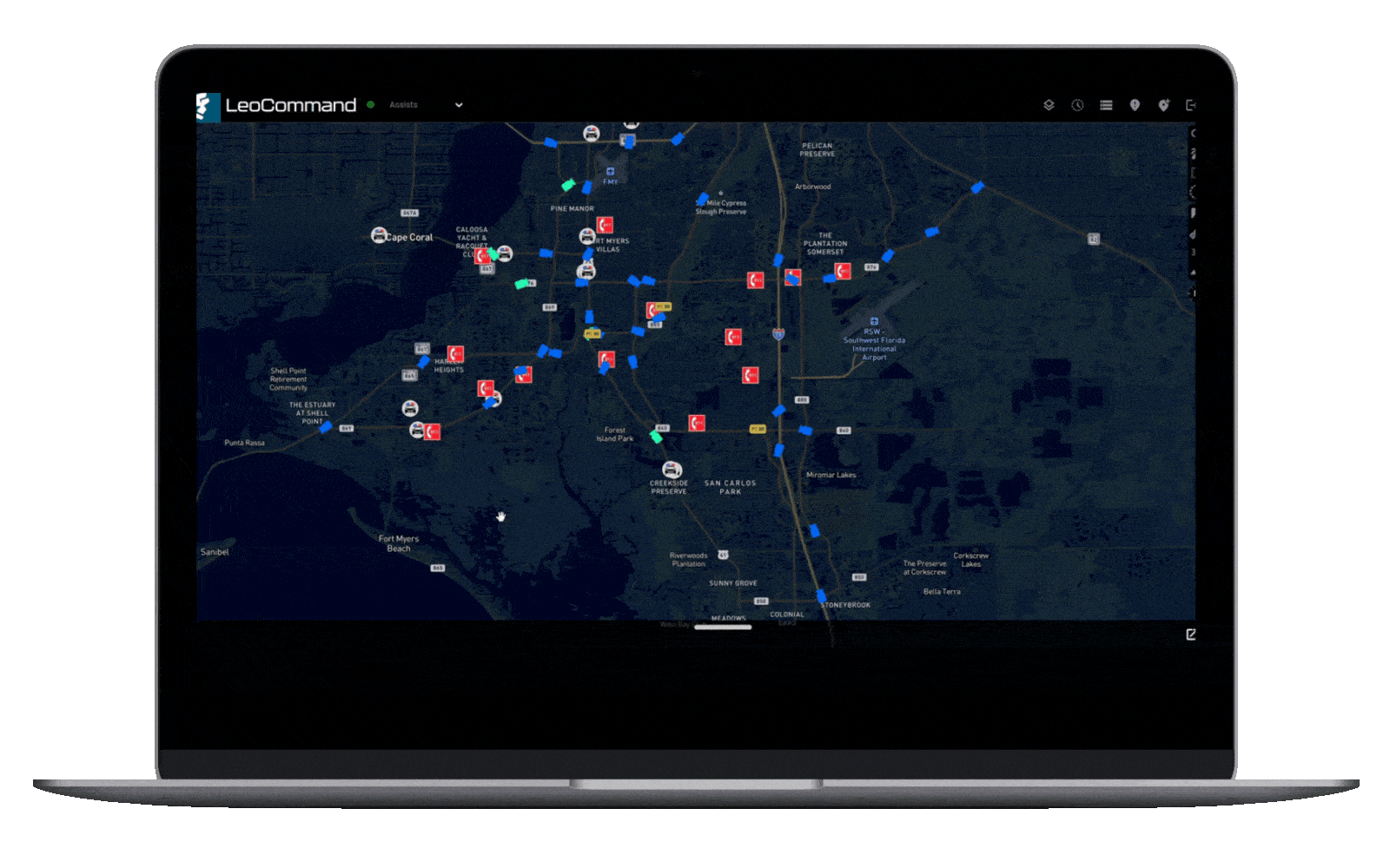 Laptop screen displaying a dark map with various icons, routes, and markers indicating locations and traffic information.