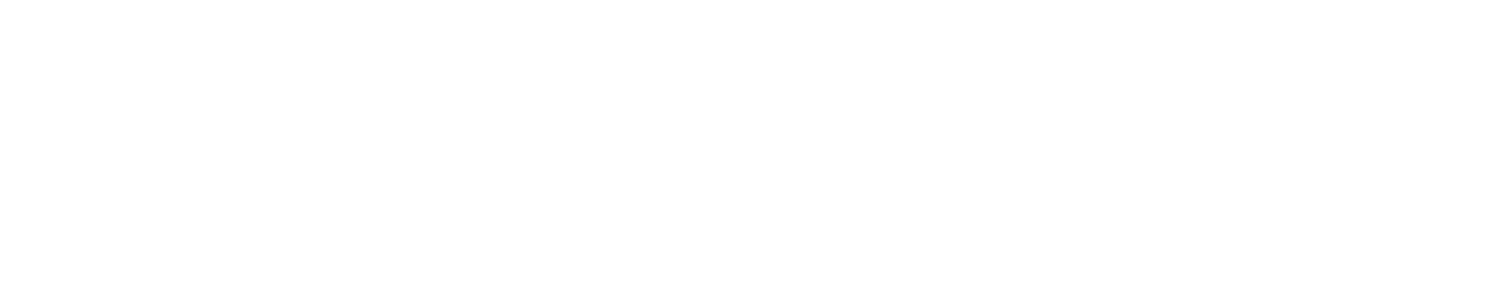 A close-up of a white ceramic mug filled with coffee on a wooden surface.