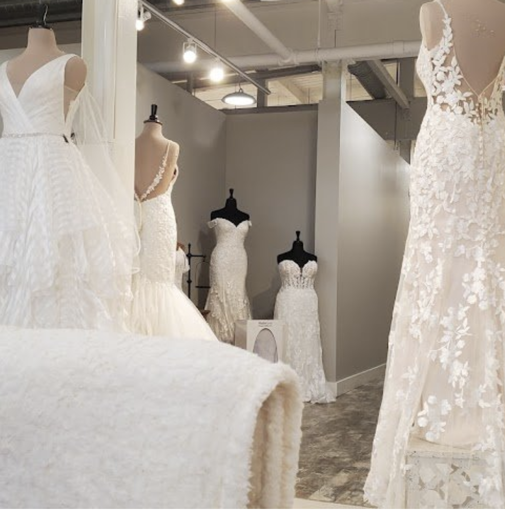 Display of wedding dresses on mannequins in a bridal boutique store