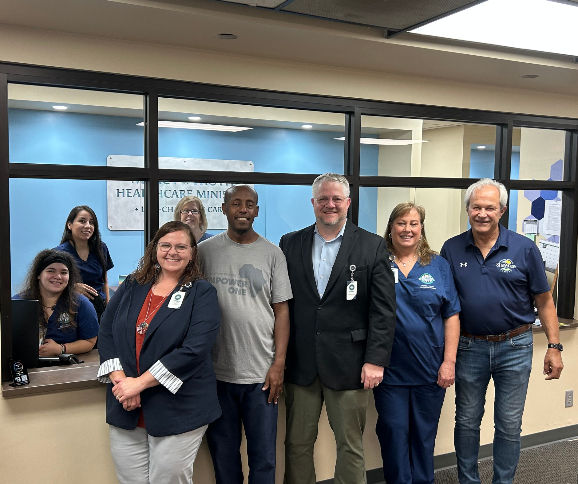 Mercy & Truth Medical Missions CEO with staff members and Shawnee Mayor Mickey Sandifer, celebrating community healthcare partnerships in Shawnee, Kansas.