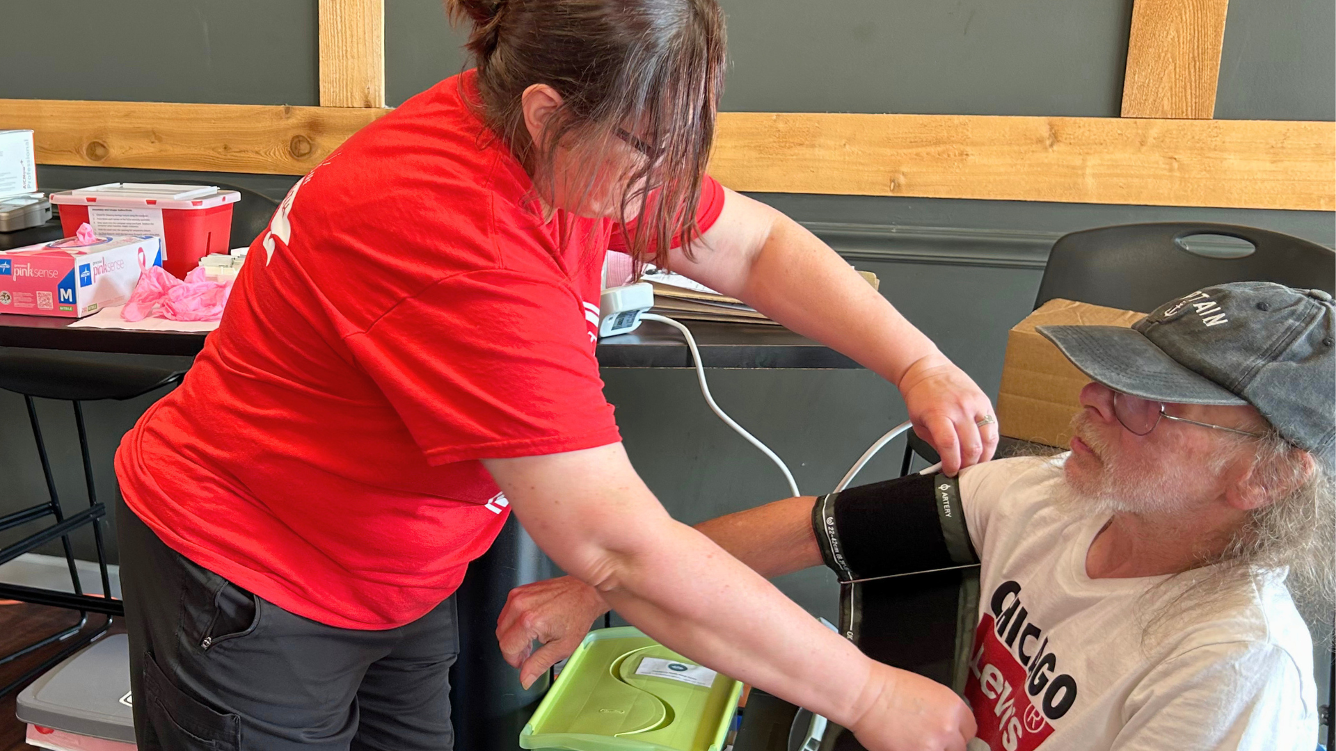 A Mercy & Truth team member checks a community member's blood pressure during the metro-wide Back to School event at Community Impact Church in Shawnee, Kansas.