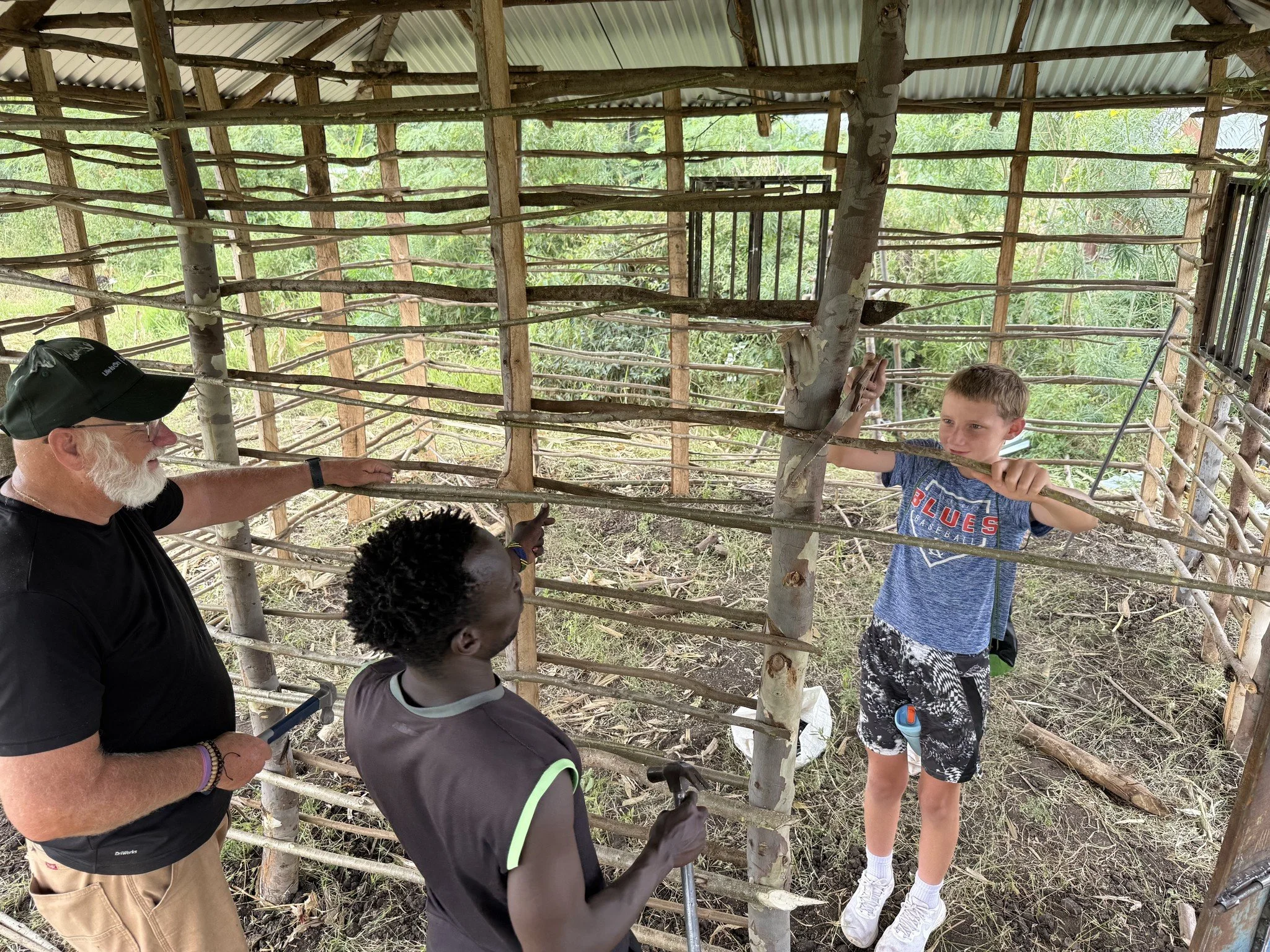 A young boy helps build a home in Kenya with the Mercy & Truth Medical Missions team, part of the Mercy & Truth Healthcare Ministry. The team provides Life-Changing Care and supports local communities through hands-on home building and healthcare.