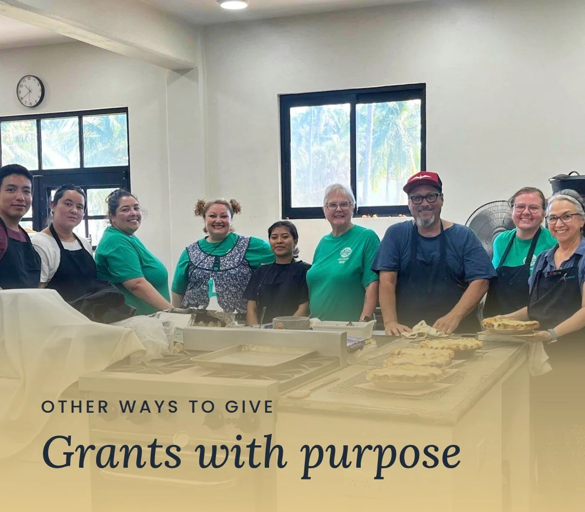 A Mercy & Truth mission team stands together in a kitchen after preparing meals to serve others. Text reads "Other Ways to Give: Grants with purpose."