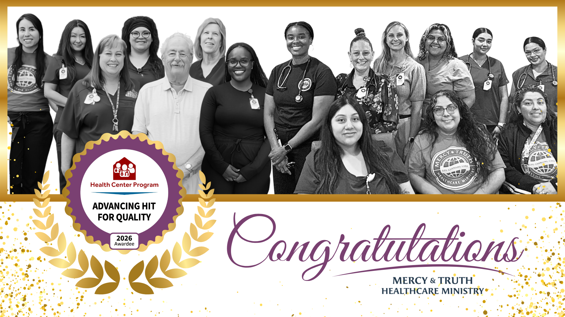 Members of the Mercy & Truth Healthcare Ministry team from the Kansas City, KS and Shawnee,KS clinics stand together and smile in a black and white group photo. Providers, nurses, and staff, several wearing scrubs, stethoscopes, and Mercy & Truth.
