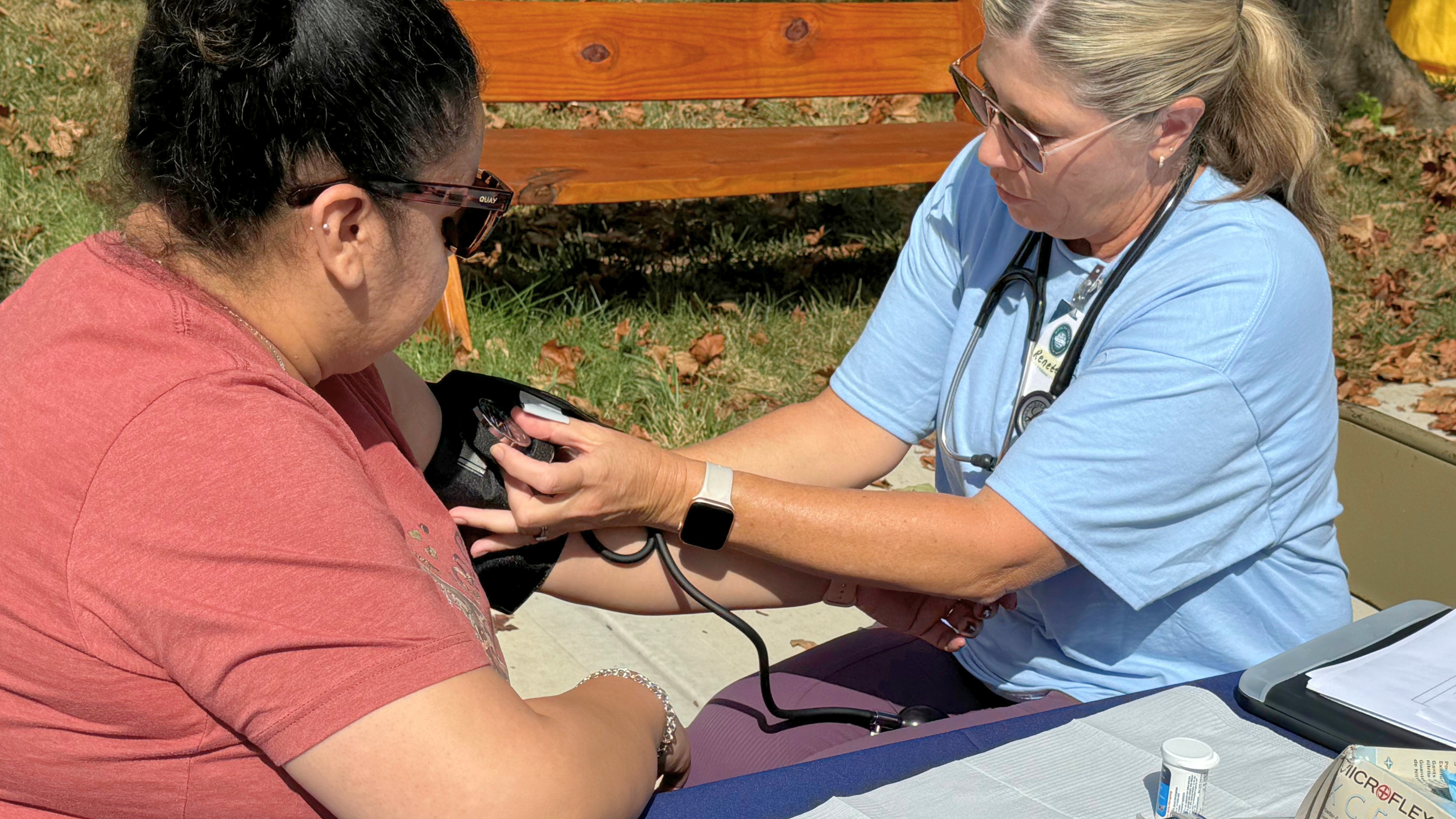Blood Pressure checks underway at an outreach event for Mercy & Truth Healthcare Ministry.
