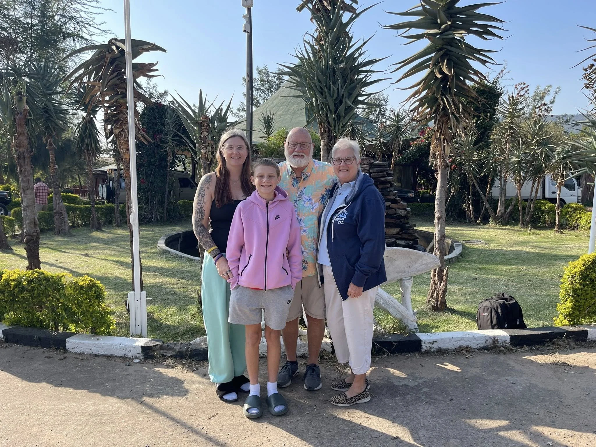 The Mercy & Truth Medical Missions team in Kenya poses in a garden during their summer mission, delivering Life-Changing Care to local communities. This work, part of the Mercy & Truth Healthcare Ministry, supports healthcare outreach.