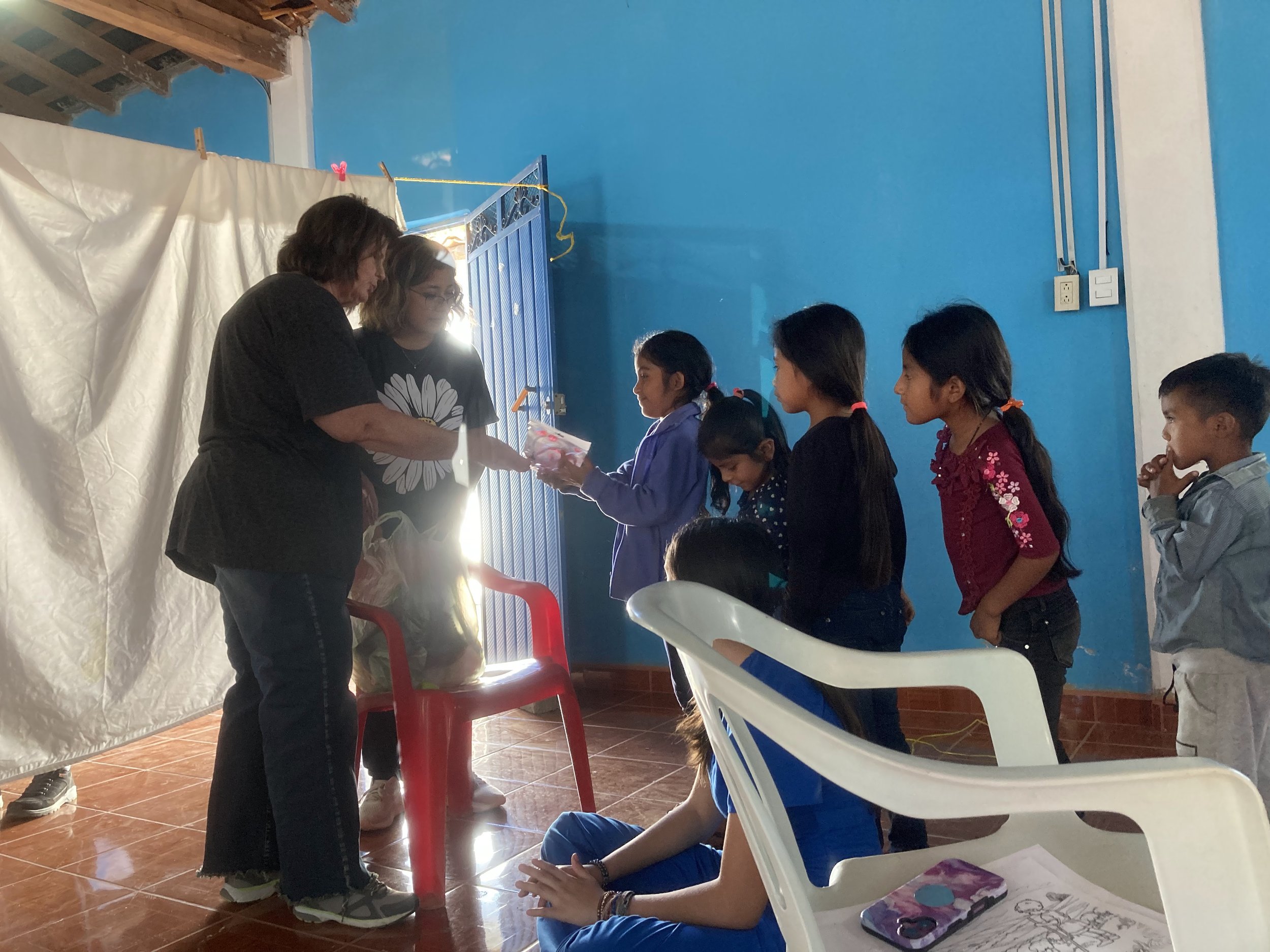 Volunteers and medical staff from Mercy & Truth Medical Missions providing Life-Changing Care and spiritual support during an international trip.