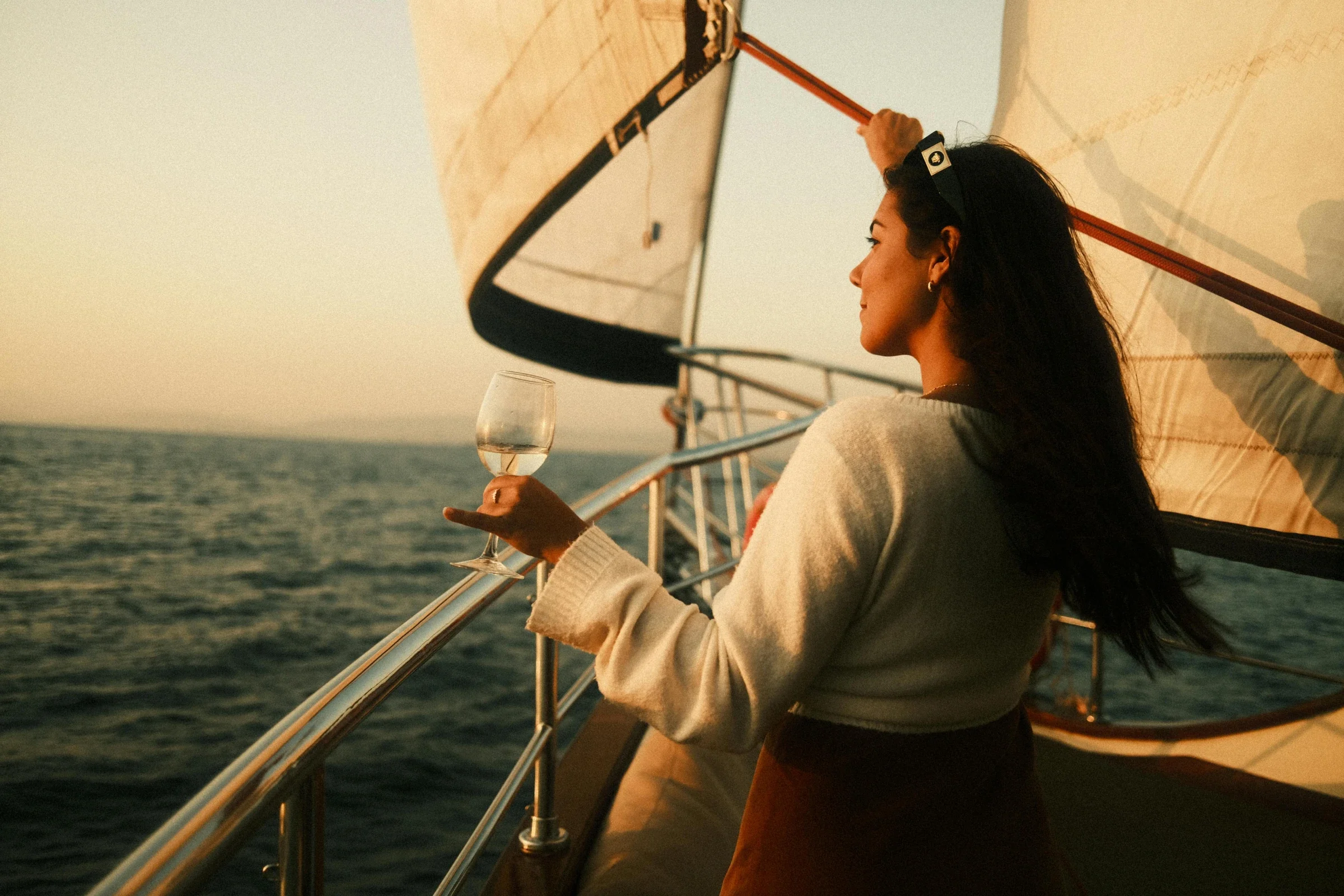 Woman sailing on the private North Shore of Chicago at sunset.