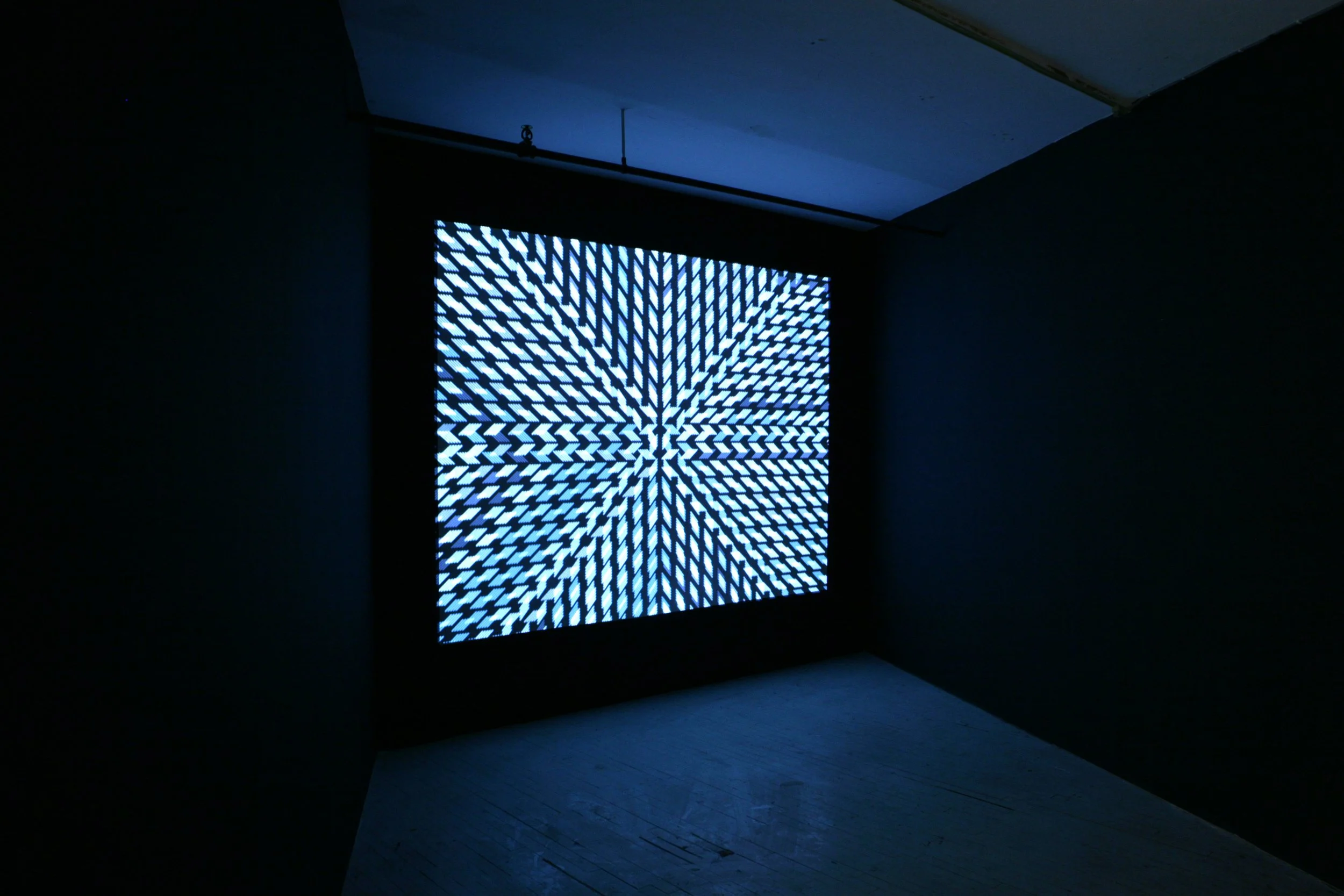 Installation view of a single-channel video animation in a parallelogram-shaped room.