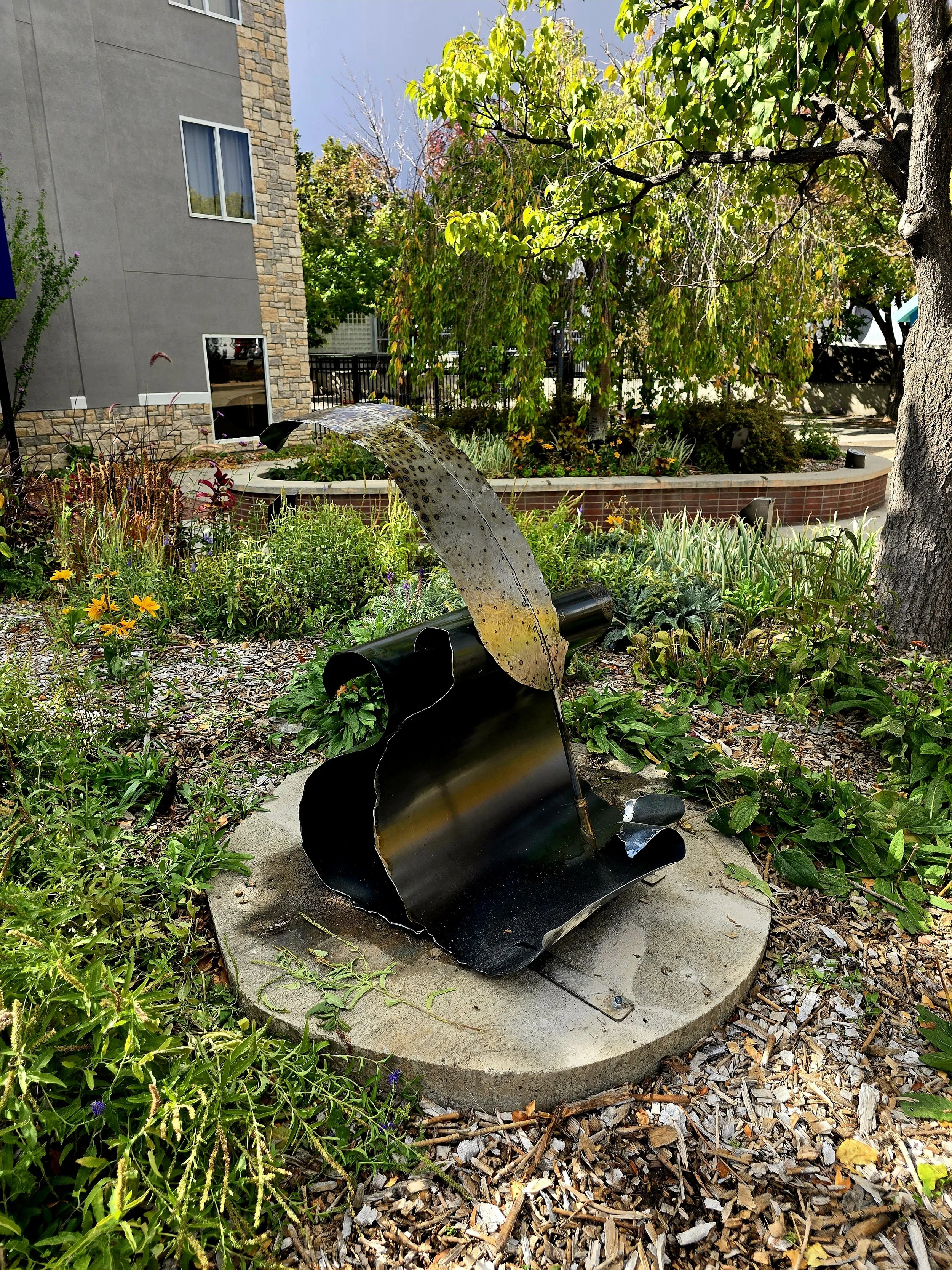 Fabricated steel feather and paper, with a bronze nib and acetylene torch patina