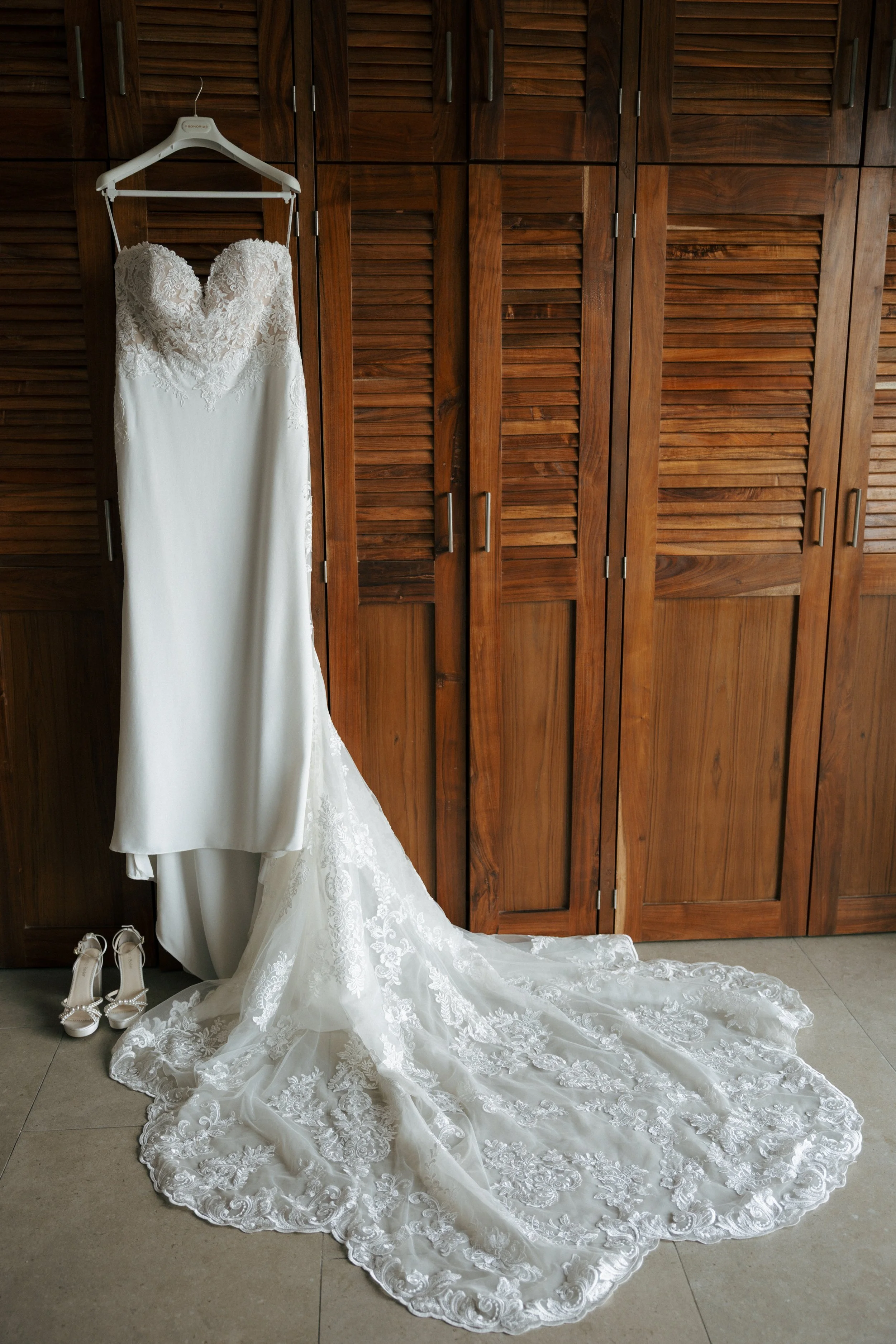 wedding dress hung on closet