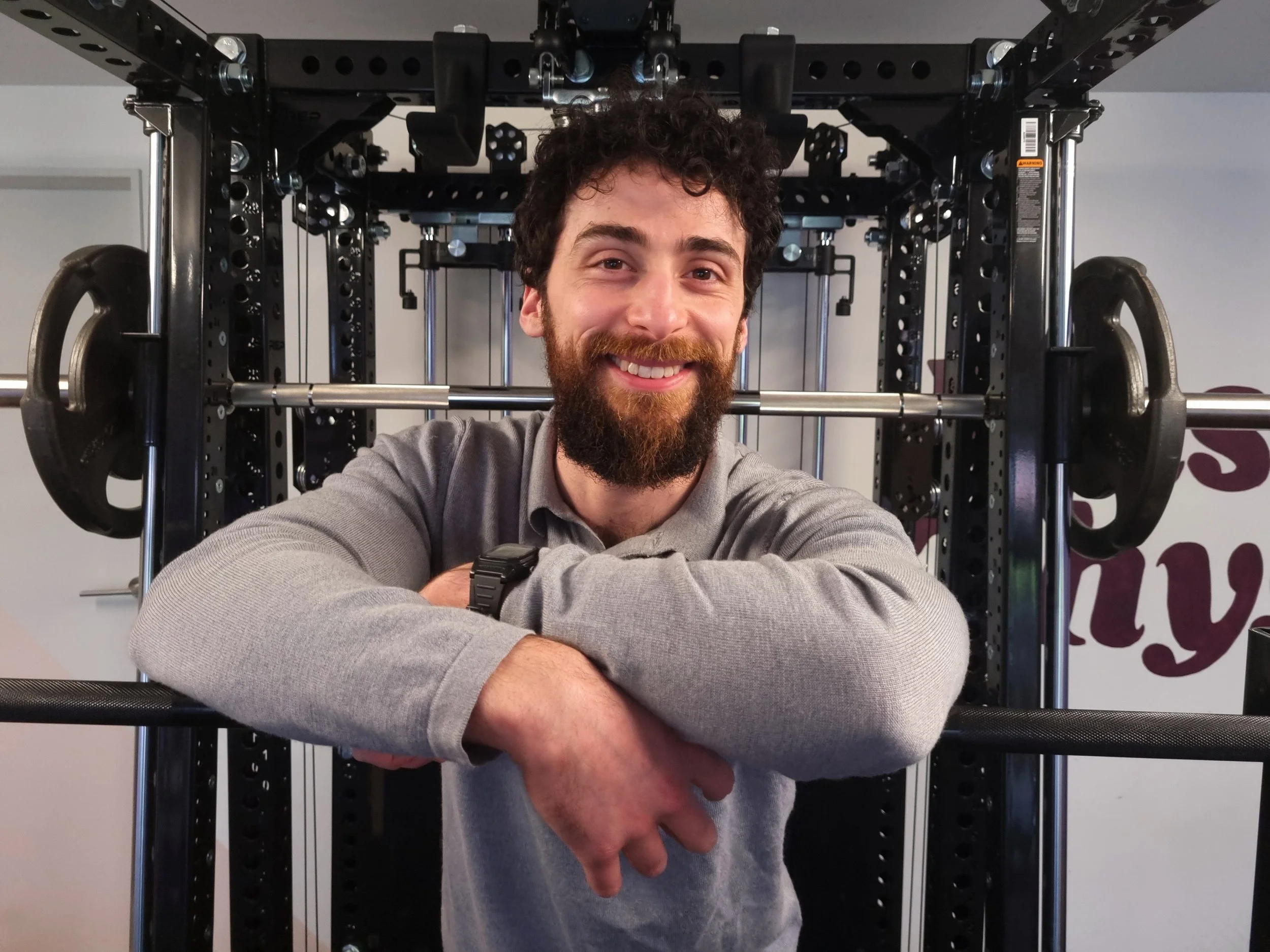 Julian Etchegoin, founder and personal trainer at Craft Fitness Studio, standing in front of the REP PR-5000 Ares 2.0.