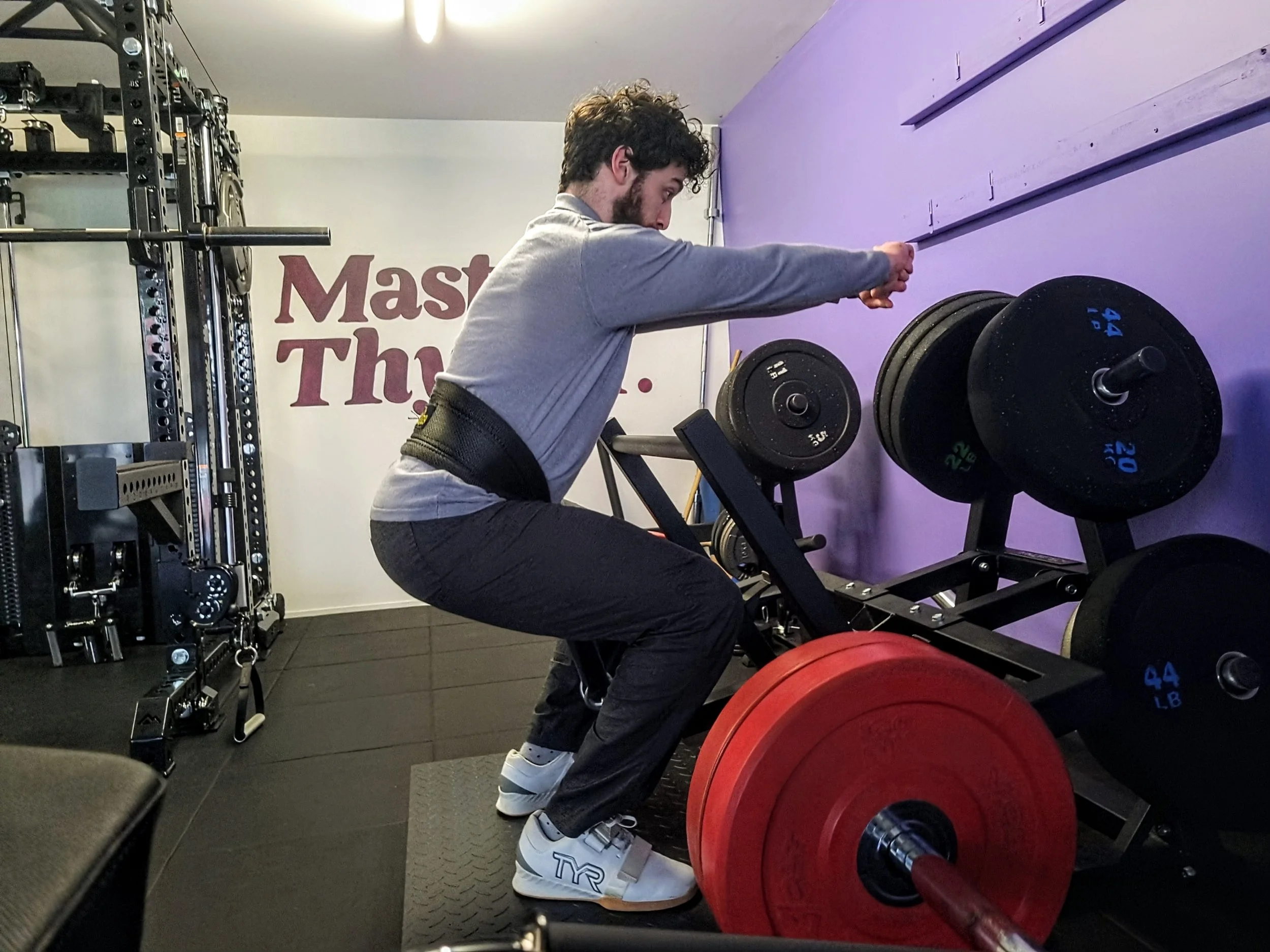 Julian Etchegoin, founder and personal trainer at Craft Fitness Studio, using the belt squat machine in his Karori Studio. 