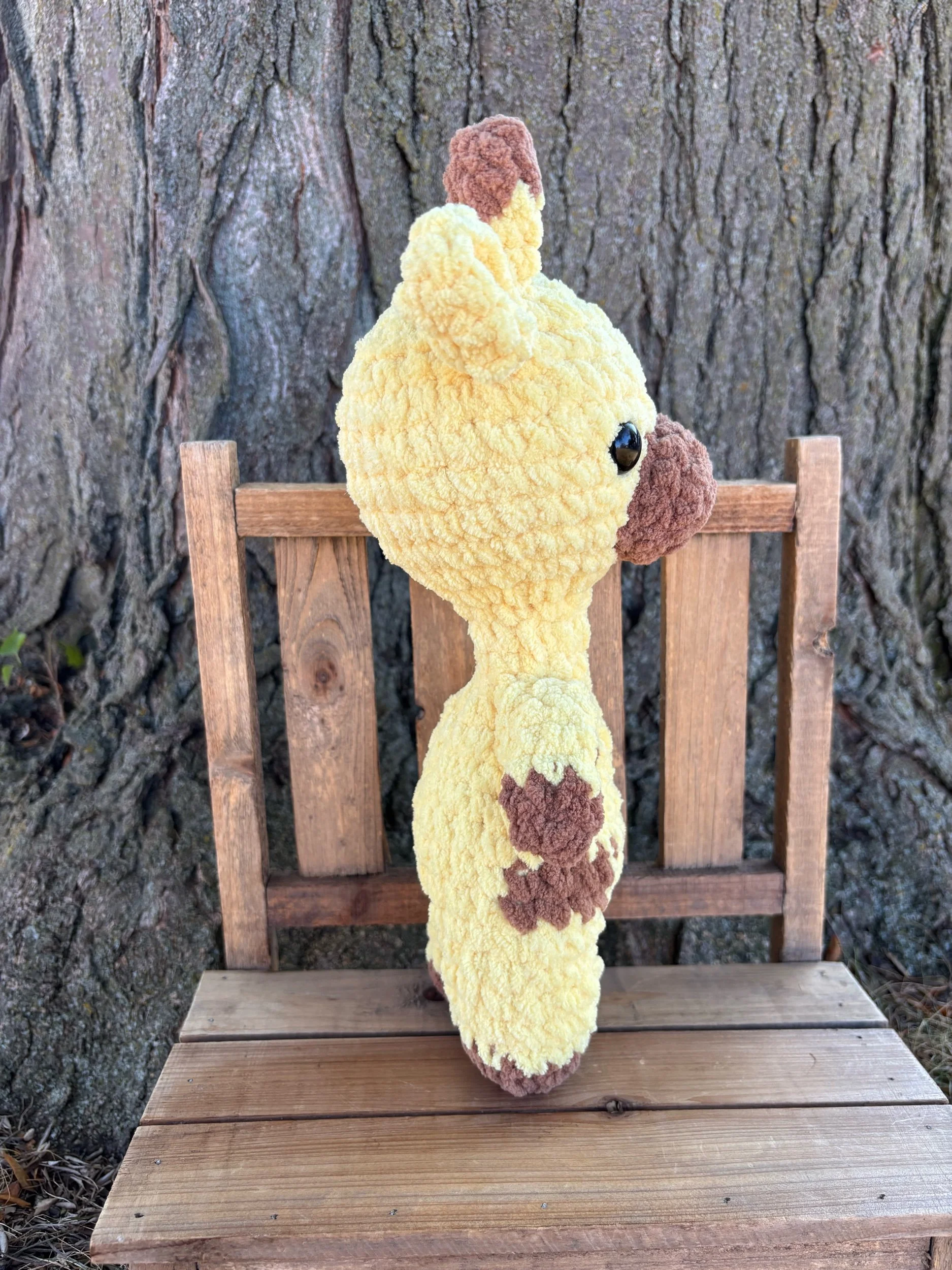 Handmade crochet giraffe plushie with brown spots