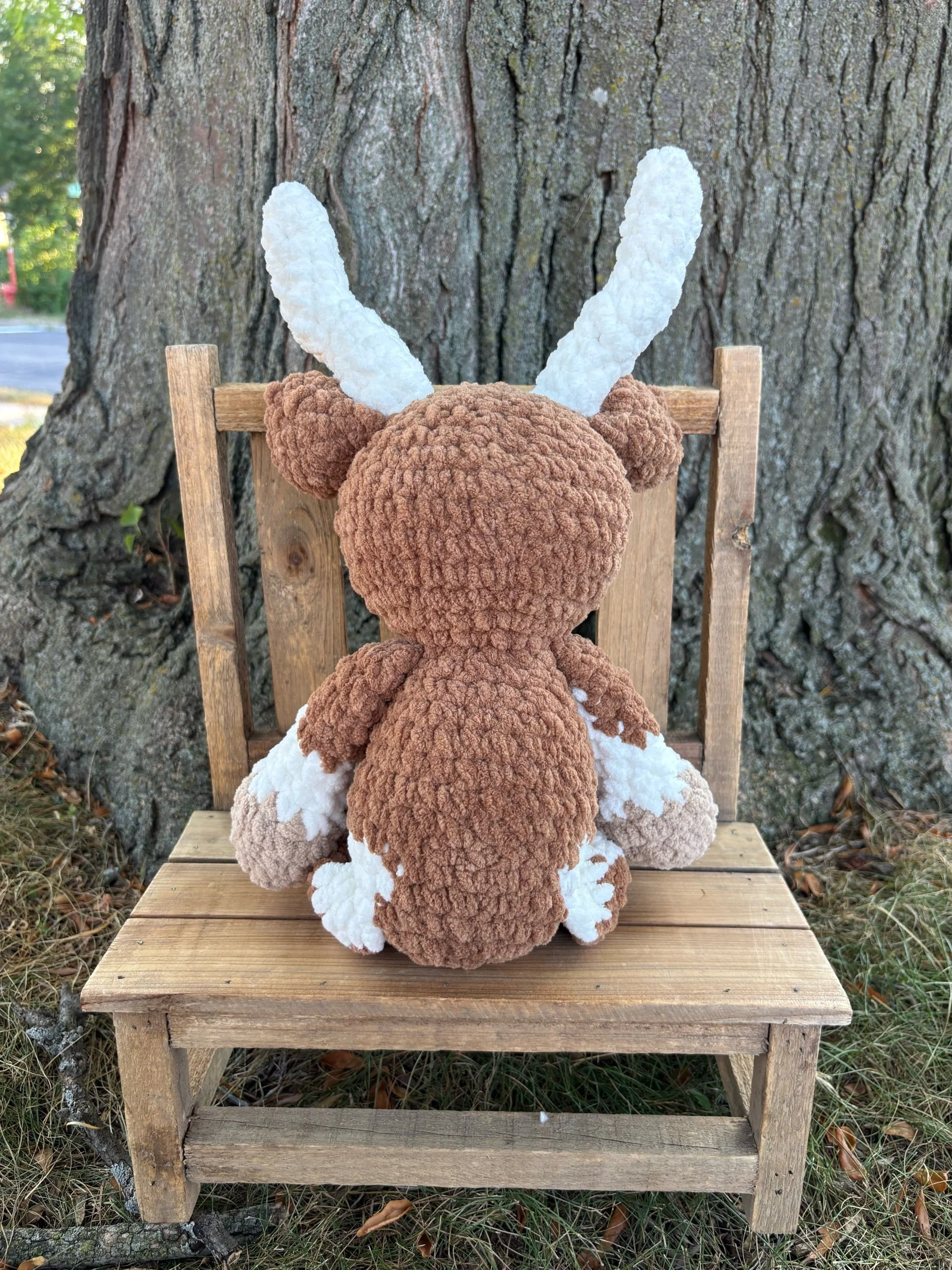 Back of crochet longhorn plushie showing horns and ears