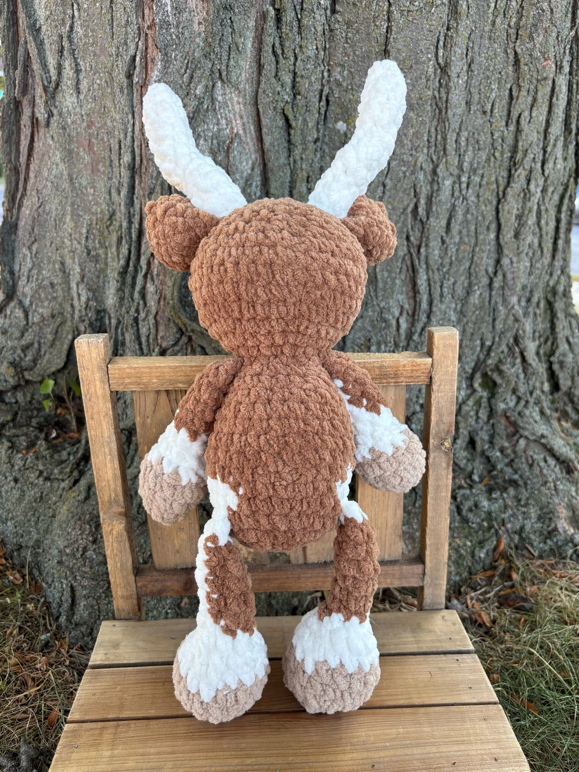 Back of crochet longhorn plushie showing horns and ears