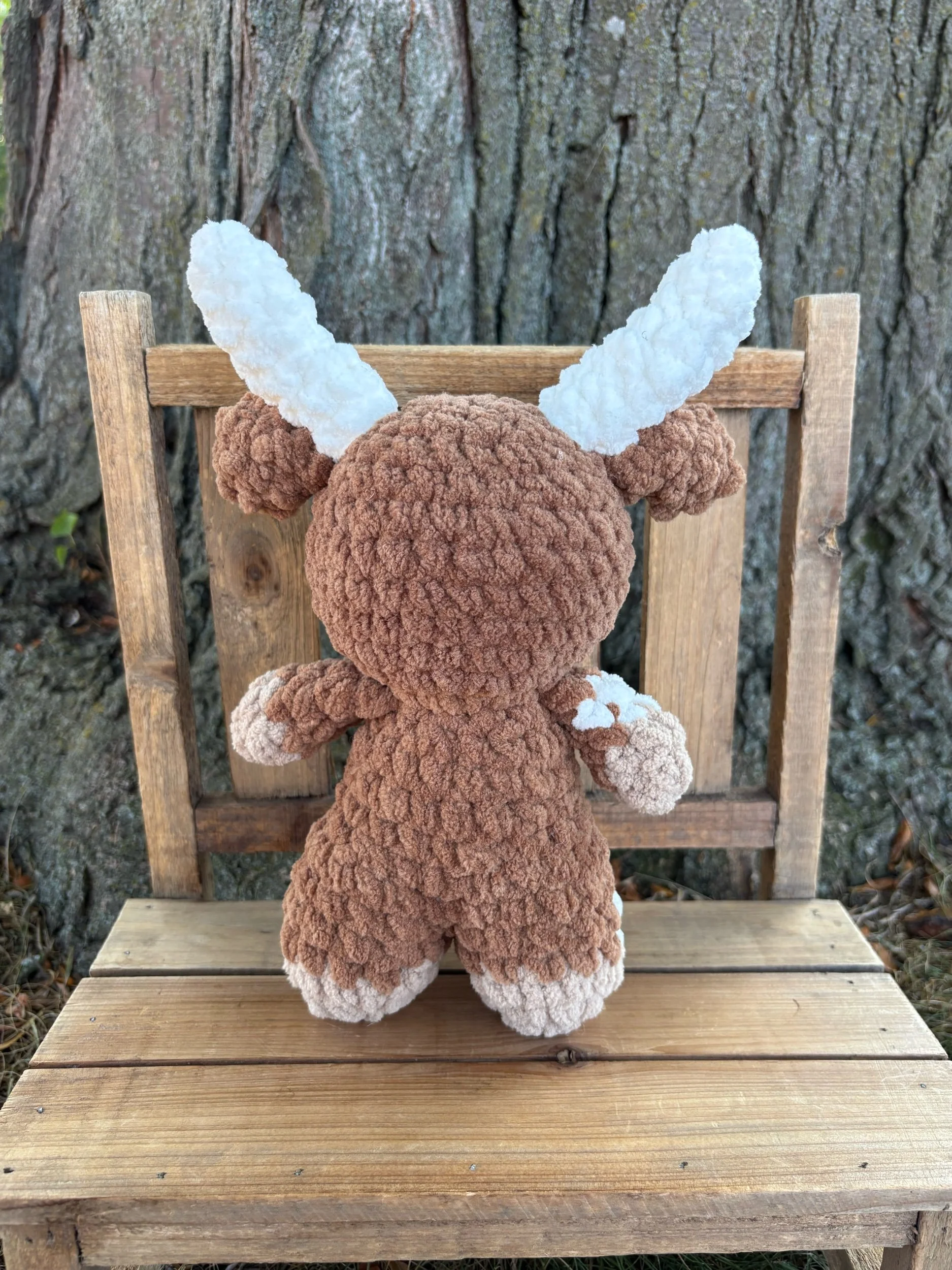 Back of crochet longhorn plushie showing horns and ears