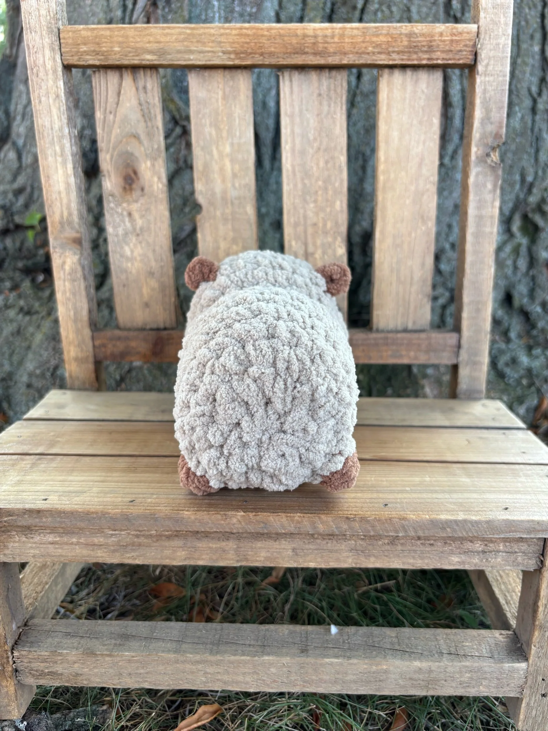 Back of crochet capybara plushie showing ears and feet