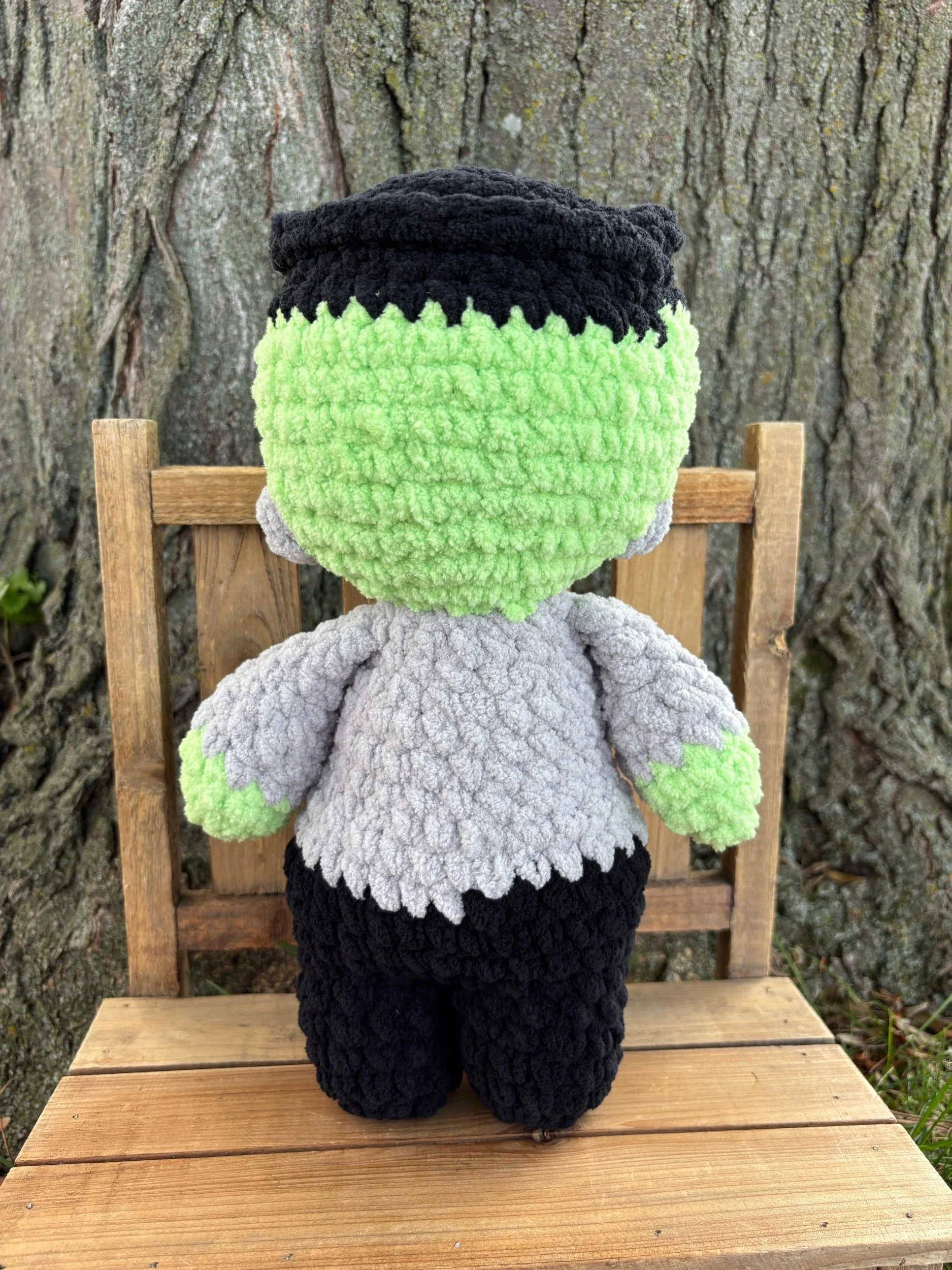 Close up of crochet Frankenstein monster plushie face and stitch scar