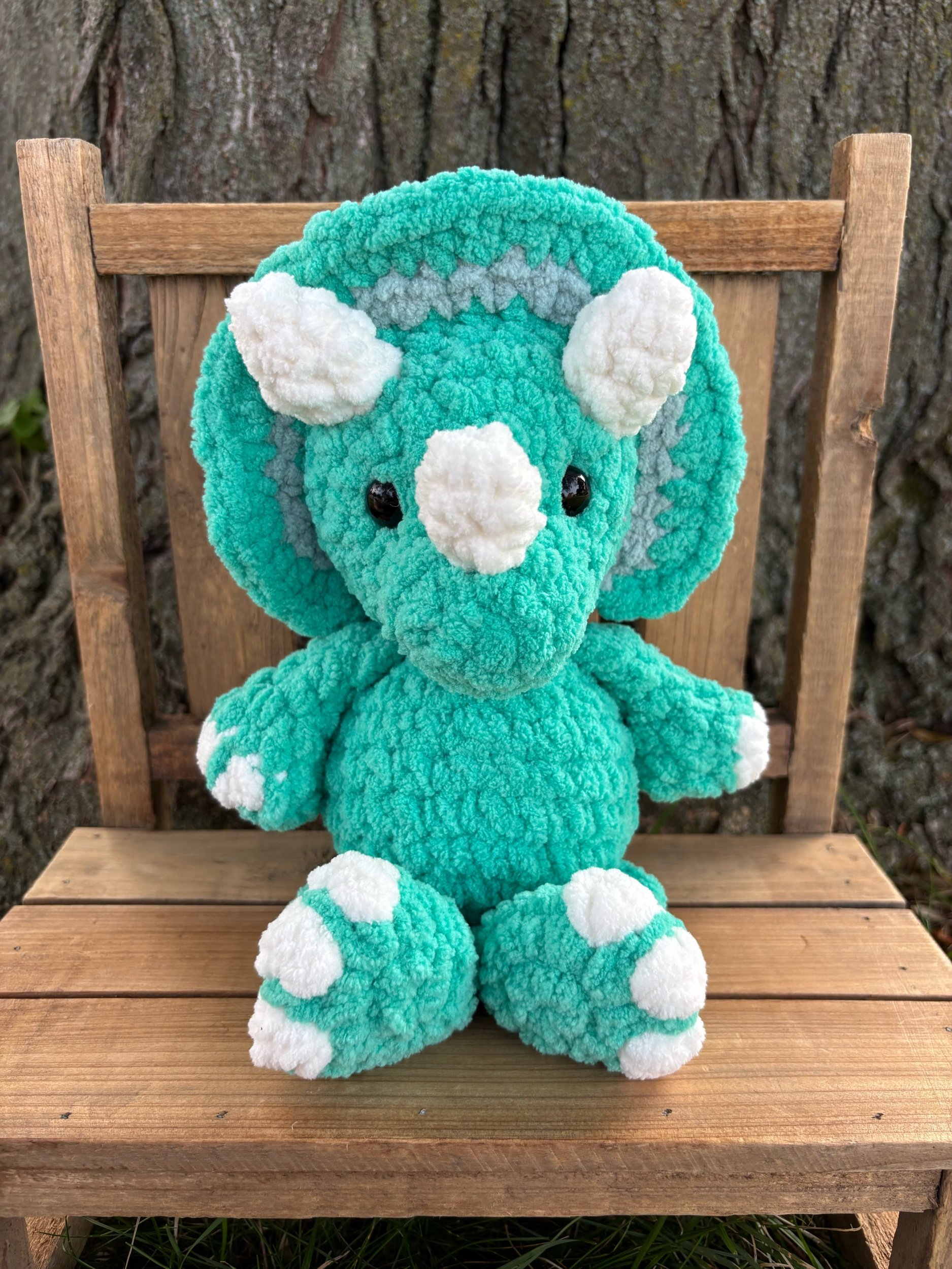 Handmade crochet triceratops plushie in seafoam green with grey frill and white horns