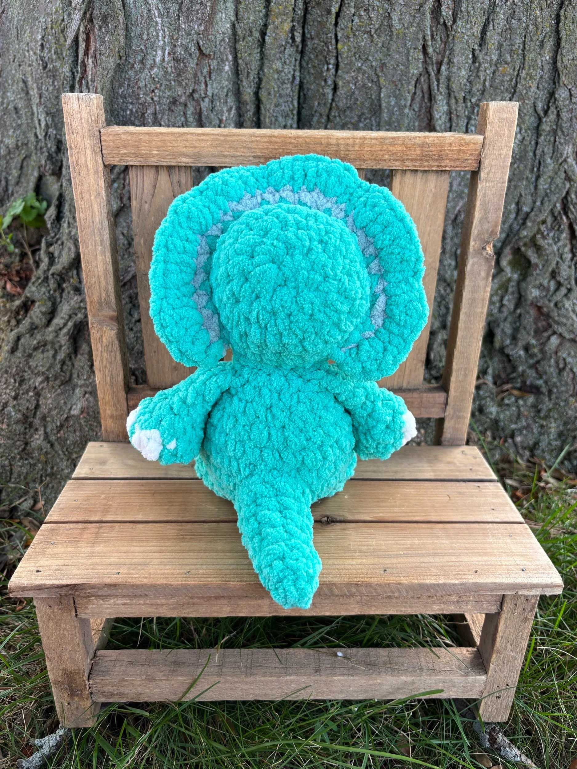 Back view of handmade crochet triceratops plushie showing frill pattern