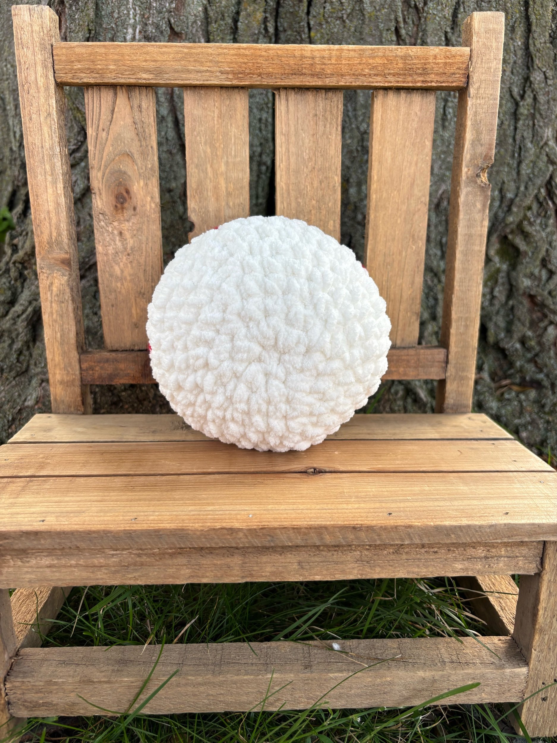 Back view of plain white handmade crochet eyeball plushie