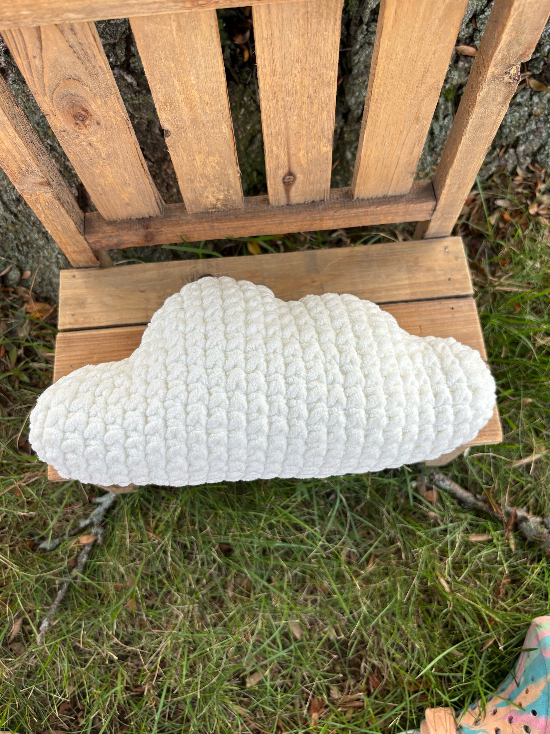 Front view of handmade crochet cloud pillow showing plush cloud shape