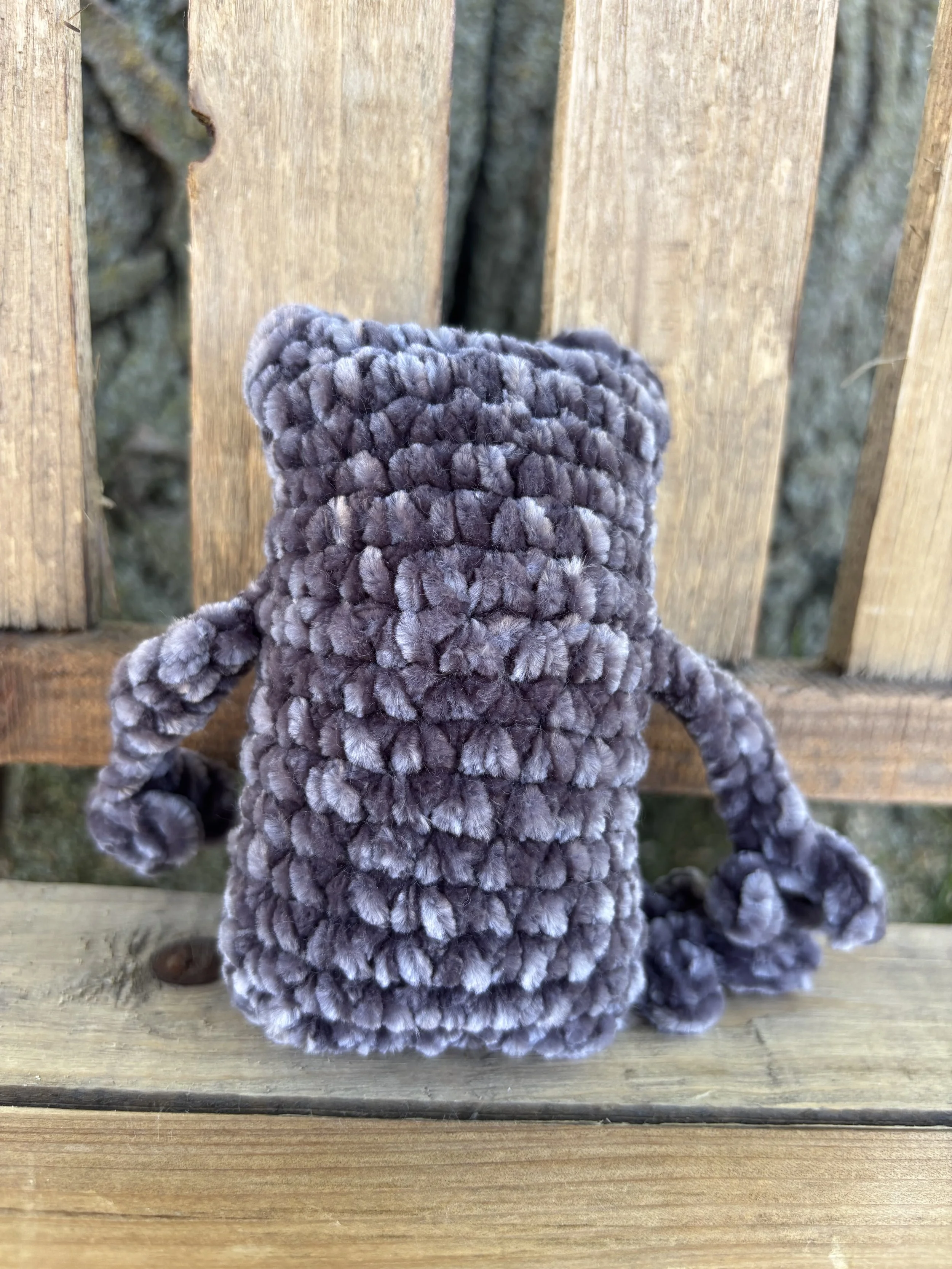 Close up of crochet velvet leggy frog plushie